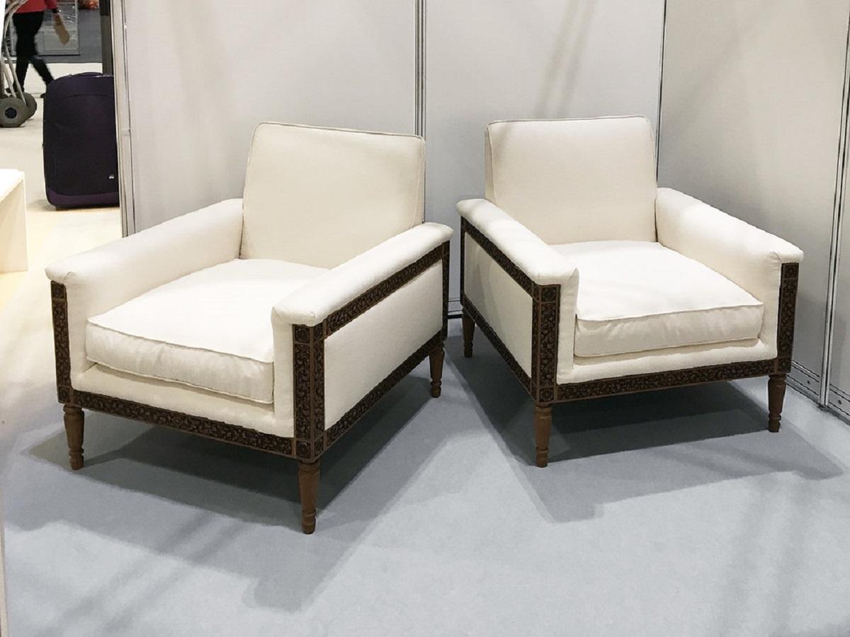 Pair of unique mid-century wood carved armchairs. The oak frame is beautifully hand carved in a floral pattern. Newly upholstered in cream fabric. The armchairs were created exclusively for its first owner. In-house upholstery is available should