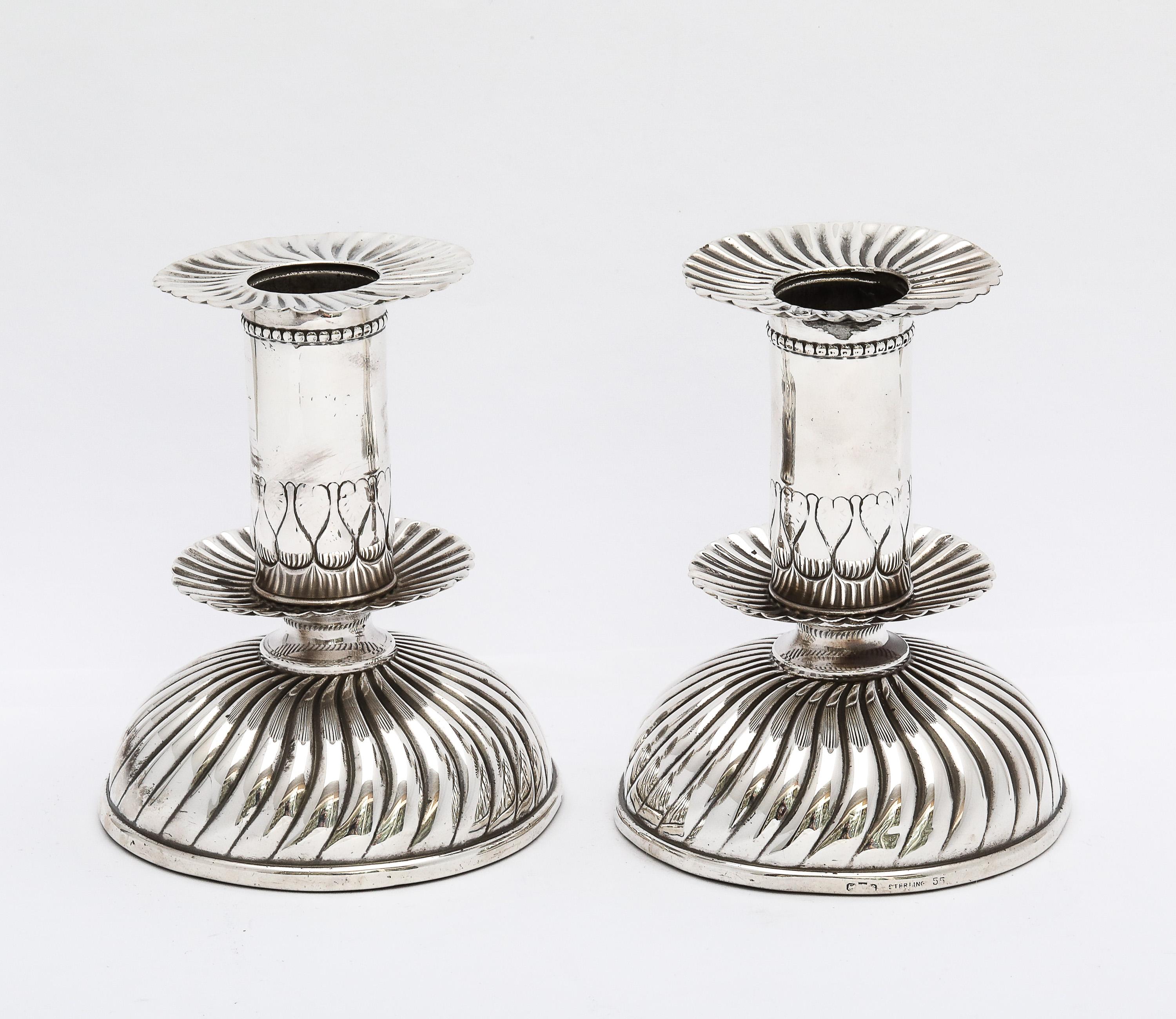 Unusual pair of sterling silver, Capstan candlesticks, in the 16th century style, Gorham Manufacturing Company, Providence, Rhode Island, Ca. 1895. Each candlestick measures 4 inches high x 3 1/4 inches diameter across base (widest point). Underside