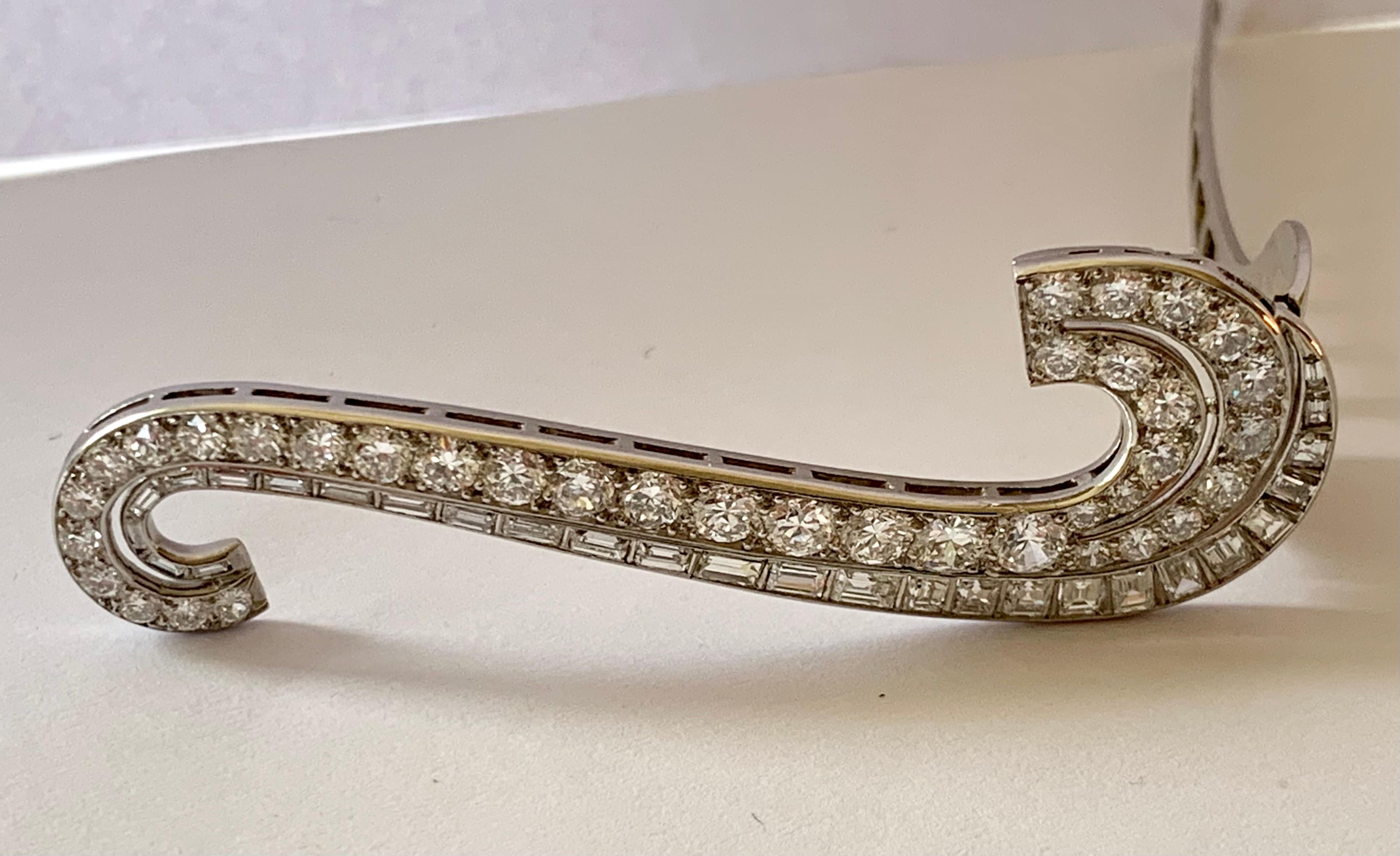  A pair of 18 K white Gold Clips brooches. They feature brilliant cut Diamonds along with baguette cut diamonds with an approximate weight of 10 ct. These beautiful brooches  can be worn as a single brooch, or as a set. A real Vintage eye catcher on