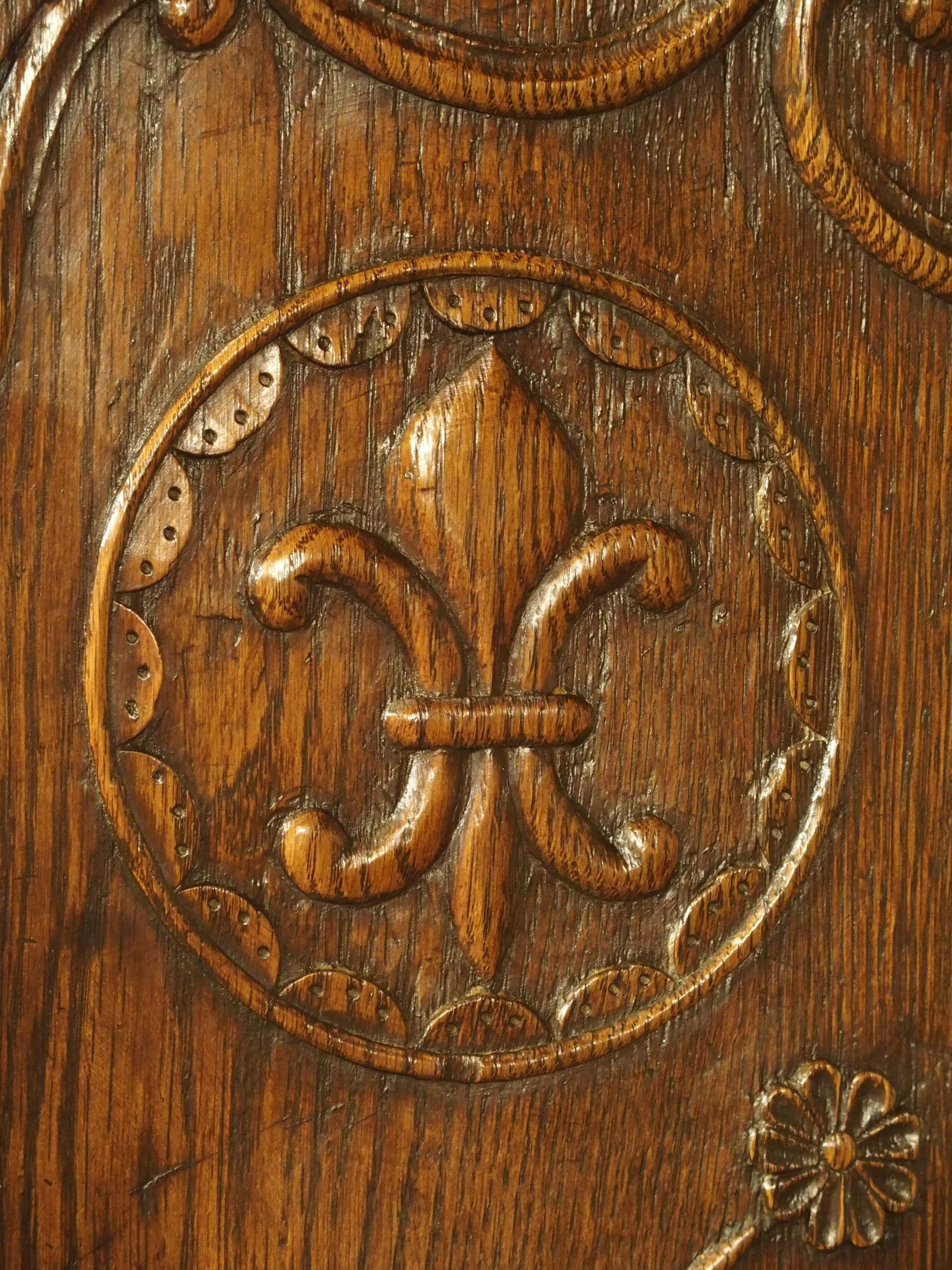 These decorative oak doors once graced the front of an armoire, or the upper section of a buffet deux corps. Based on the style of carving, it is likely they are from Northern Brittany or Southern Normandy. Each door is asymmetrical in its design