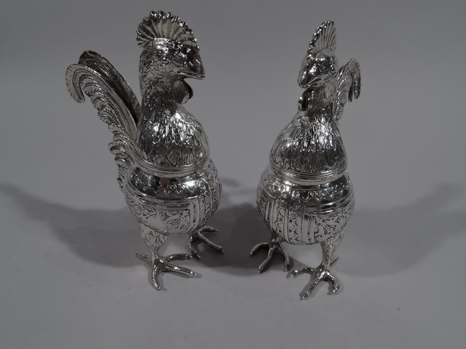 Pair of unusual and delightful German sterling silver spice boxes. Imported to England in 1895 by Berthold Muller in London. Each: Globular body with chased scrolls and paterae in curvilinear frames. Chubby drumstick legs terminating in big, scaly