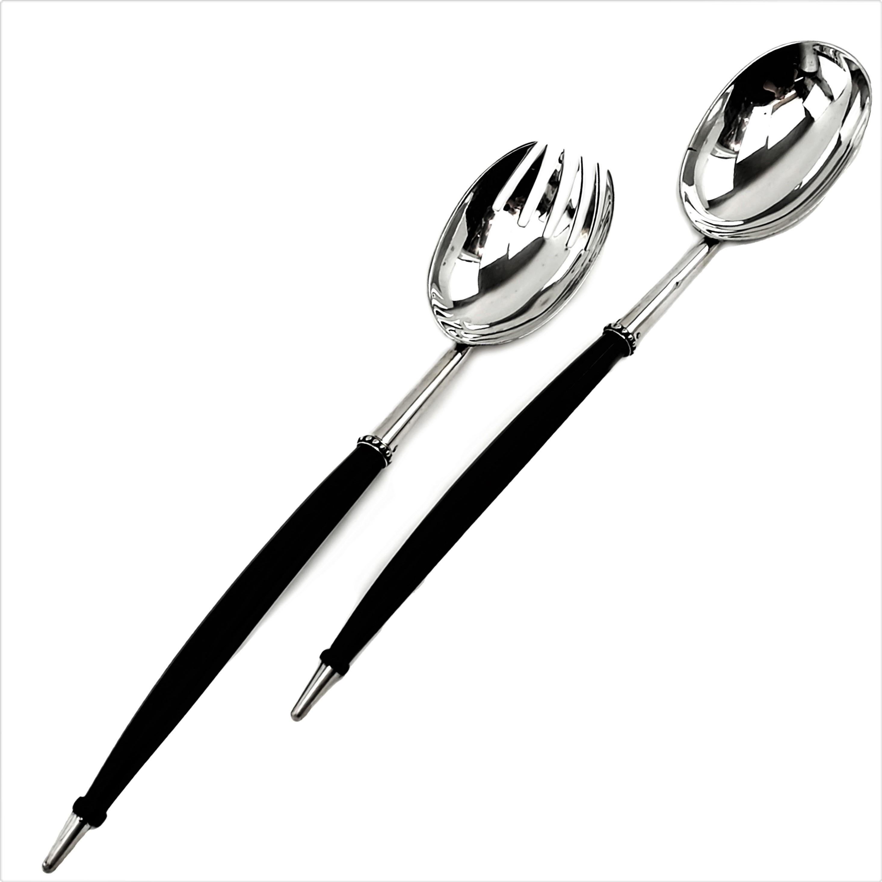 A pair of unusual sterling Silver Salad Servers with octagonal dark brown wooden handles and solid solver bowls, necks and tips. These simple, elegant Servers are embellished only with a subtle beaded band around the top of the handles. The set has