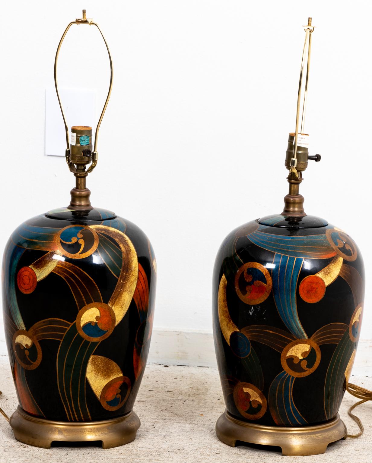Pair of Art Deco style glass table lamps with stylized geometric shapes and Chinese style fretwork finial. Please note of wear consistent with age including chips, paint loss, and finish loss.