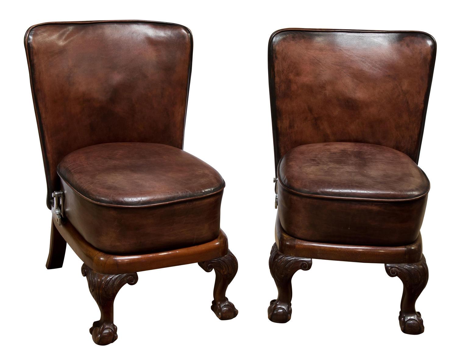 Pair of unusual mahogany framed leather upholstered folding chairs on ball and claw feet. Possibly vintage car seats. Hand dyed leather, circa 1920.