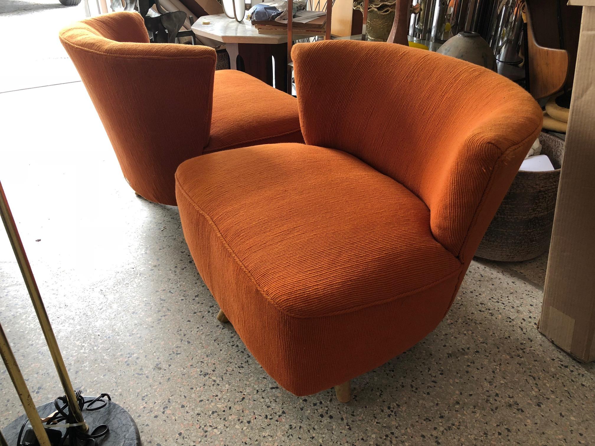 A pair of stylish and comfortable swivel lounge chairs by Kroehler in original orange nubby fabric.