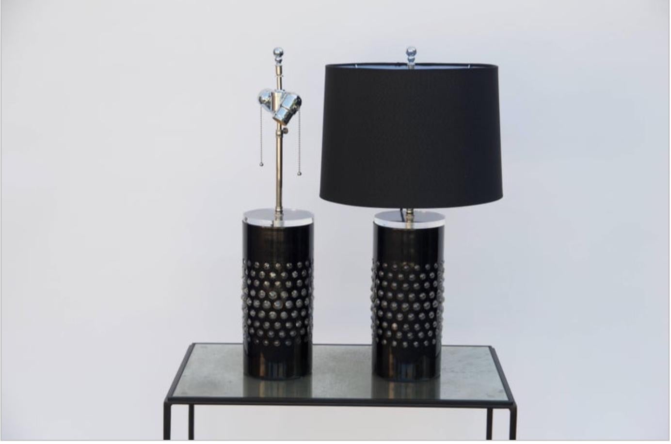 Pair of unusual textured glass cylinder lamps with custom shades, circa 1980. Rewired with custom black silk shades. The transparent top piece of the columns lets the light through the base glass ball openings.

Drum shade measurements: 13 in.