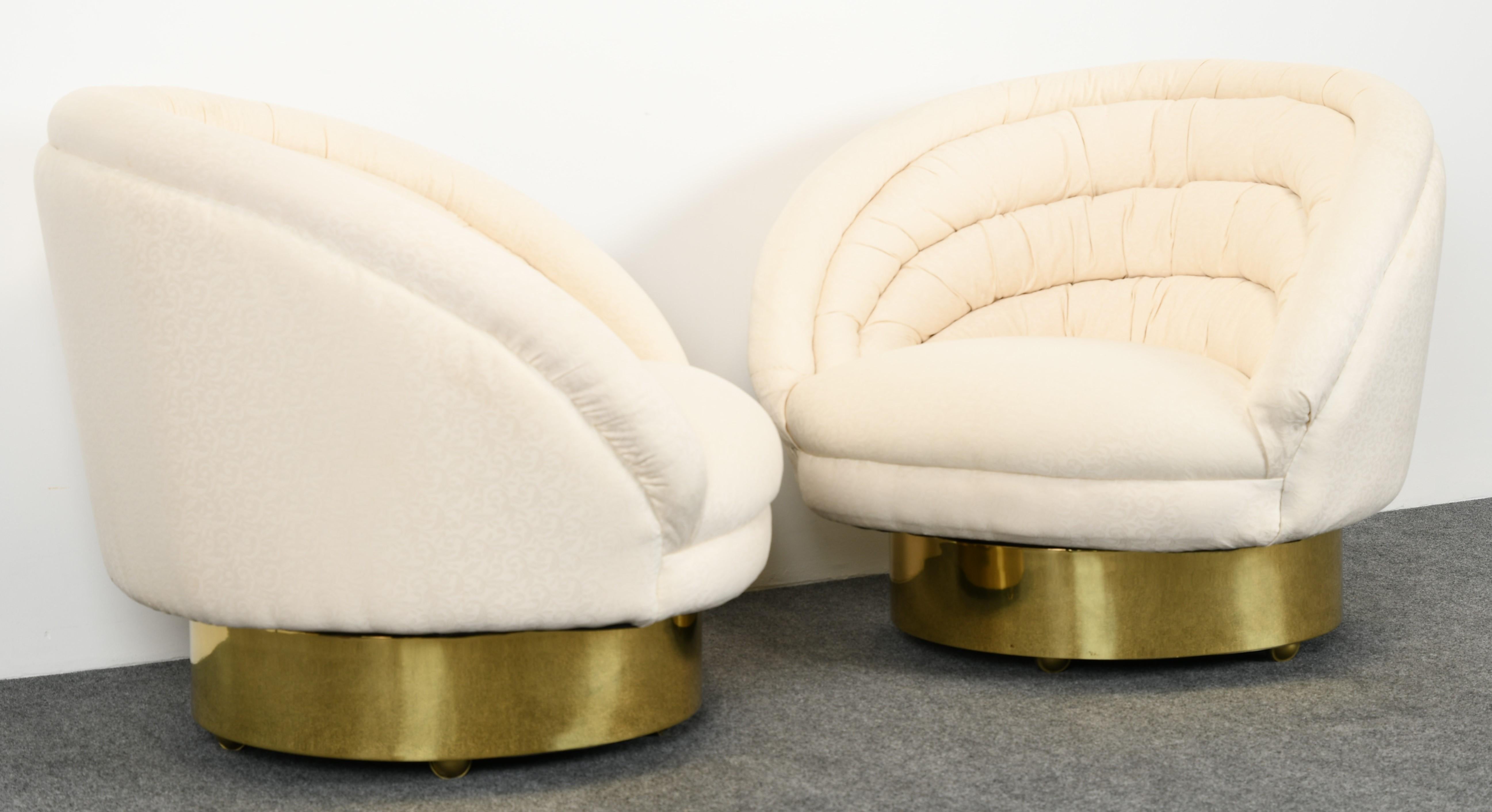 A stunning pair of upholstered tufted swivel lounge chairs on brass bases by Vladimir Kagan. Very good vintage condition with age appropriate wear, as shown in images. New upholstery recommended.

Dimensions: 31