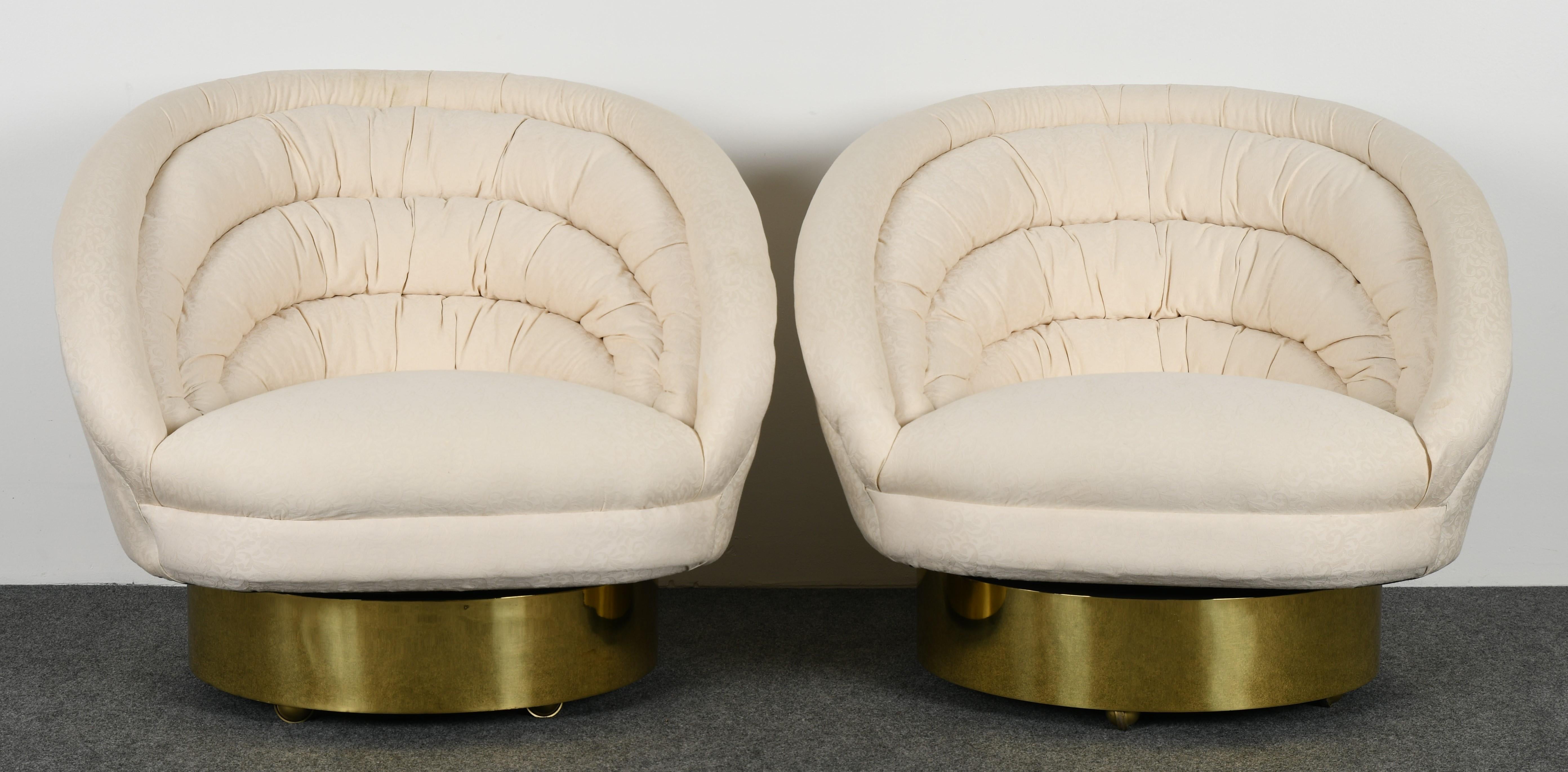 A stunning pair of upholstered tufted swivel lounge chairs on brass bases by Vladimir Kagan. New upholstery recommended.

Dimensions: 31