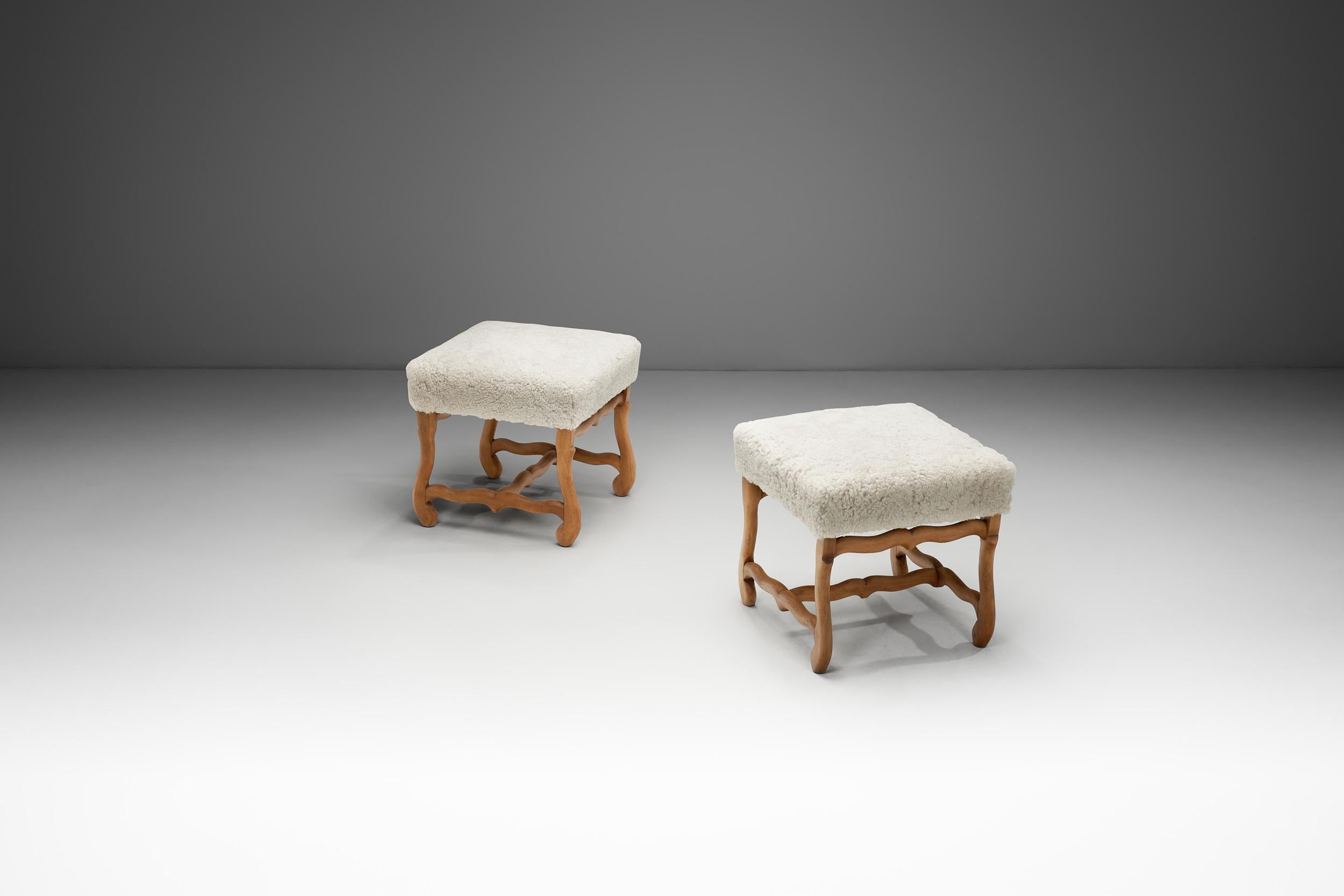 With their gentle curves and inviting texture, this pair of upholstered footstools embodies the refined craftsmanship and understated charm of mid-20th century European design. Combining comfort, artisanal detail, and visual interest, they offer a