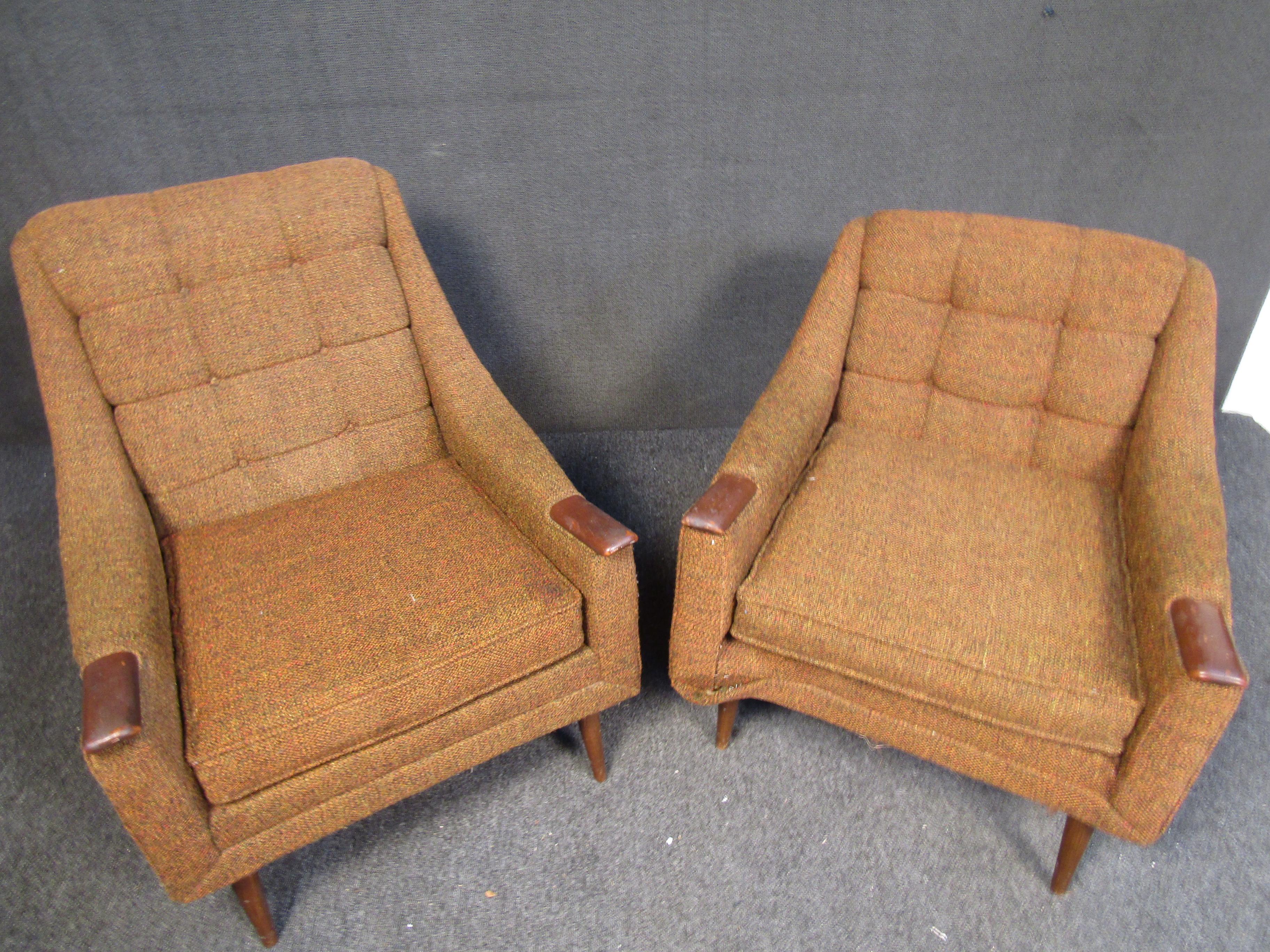 Set of upholstered and walnut chairs. The pair features two different versions often called 