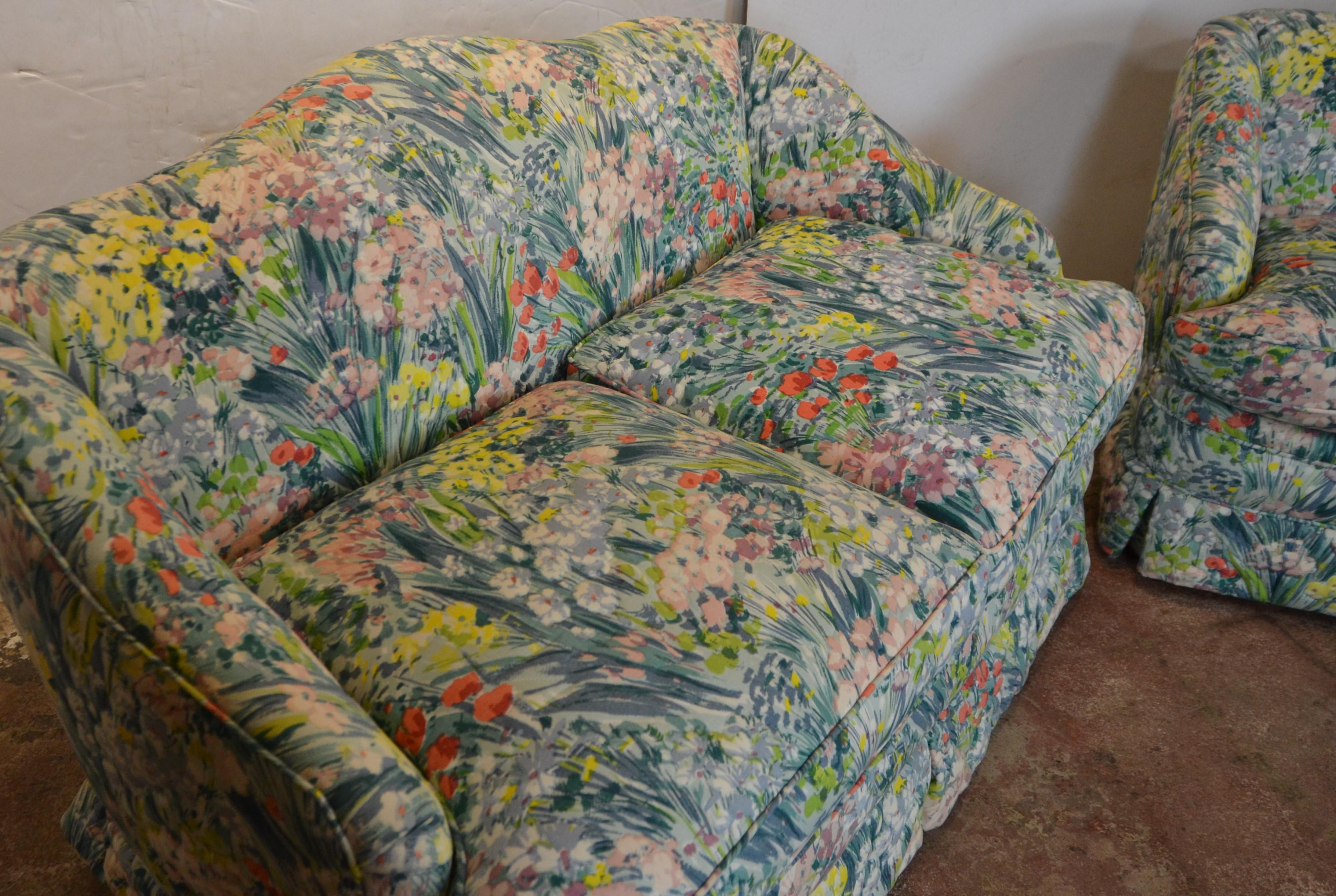 Pair of upholstered loveseat. Flower pattern fabric with loose cushions filled in down.