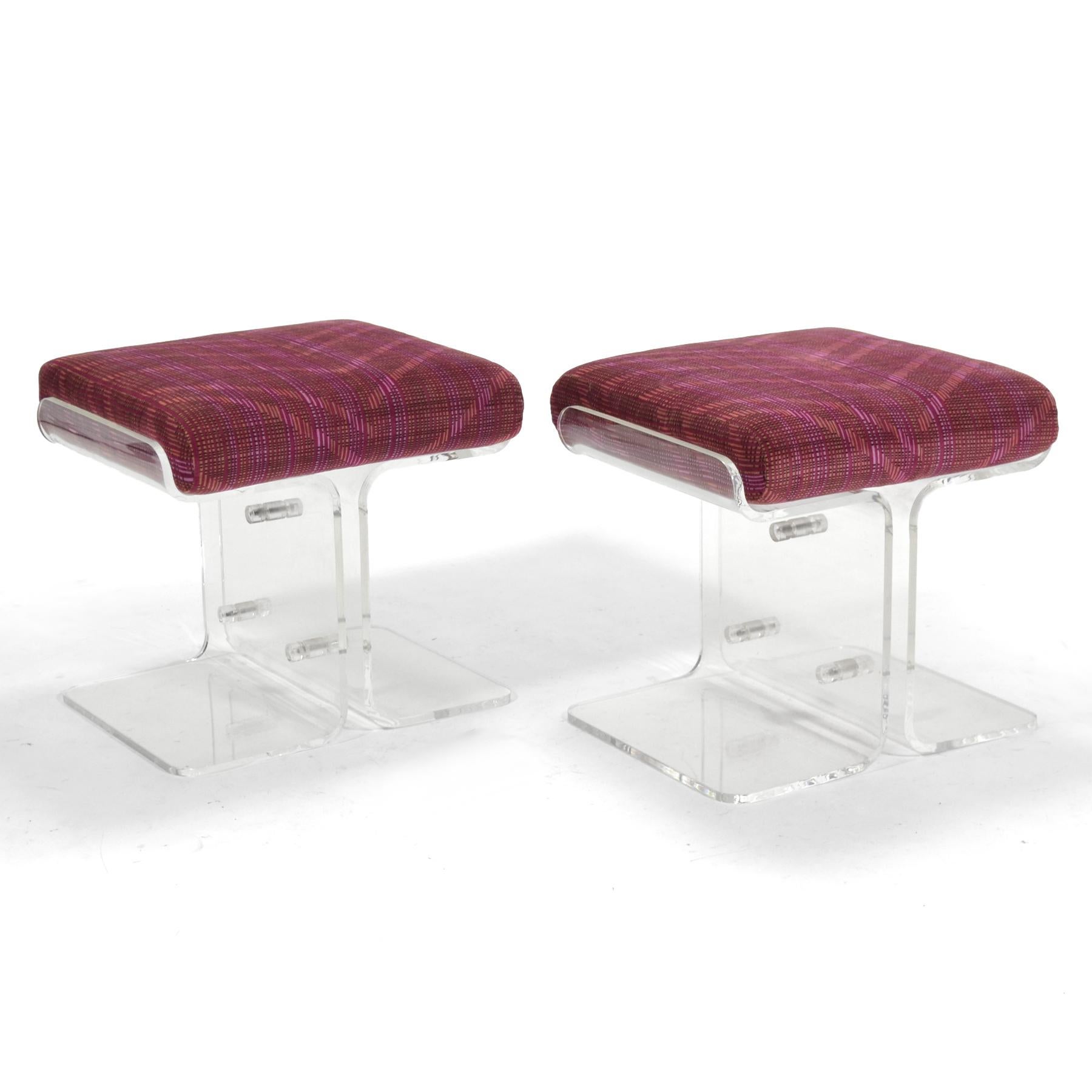 This pair of beautiful stools use clear lucite to great effect. The symetrical bases are fastened in the center and cradle a loose upholstered seat cushion. Dating to the late 1970s, they remain in excellent condition.