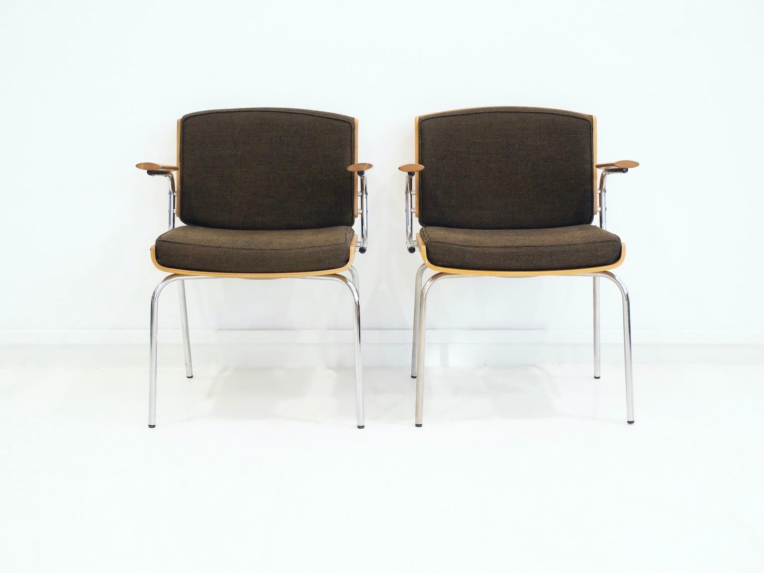 Pair of chairs with chrome-plated tubular steel frame. Seat and backrest made of molded oak plywood, dark brown fabric upholstery. Manufactured in Denmark, labeled underneath by Duba Møbelindustri.