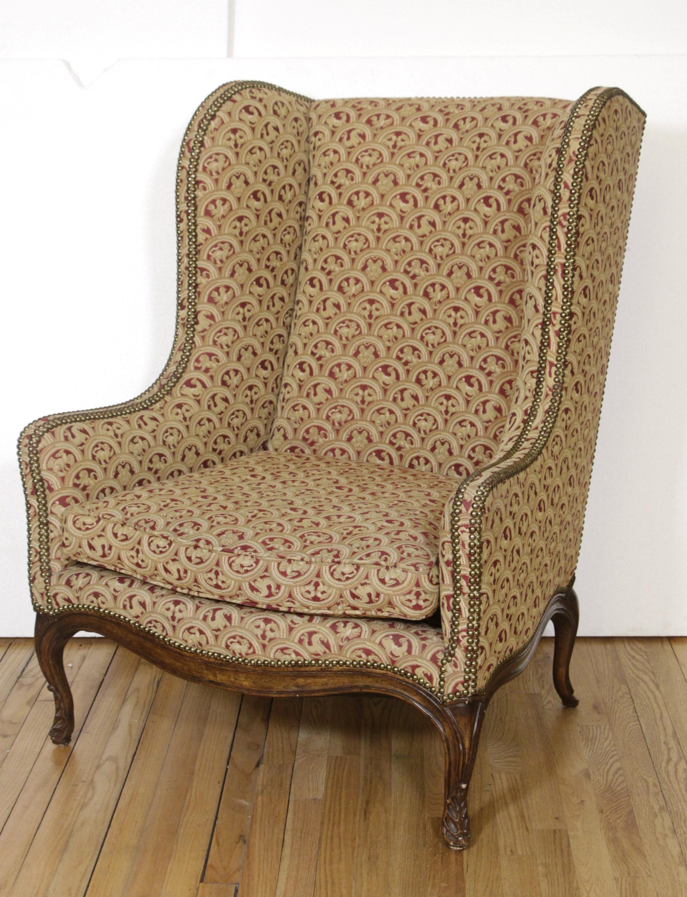 Pair of Upholstered Tan Wing Back Chairs w/ Ornate Figural Details In Good Condition In New York, NY