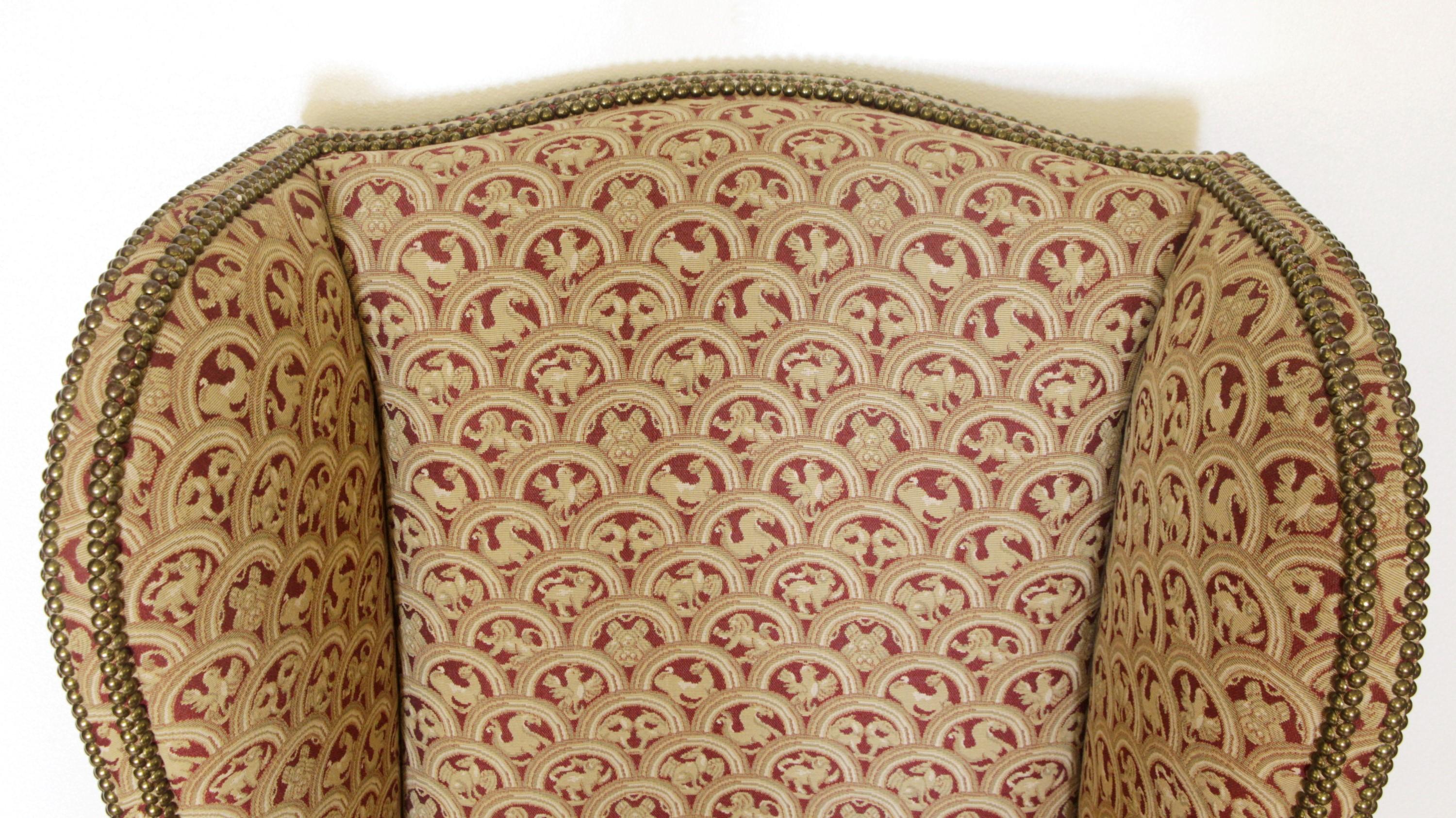 Fabric Pair of Upholstered Tan Wing Back Chairs w/ Ornate Figural Details