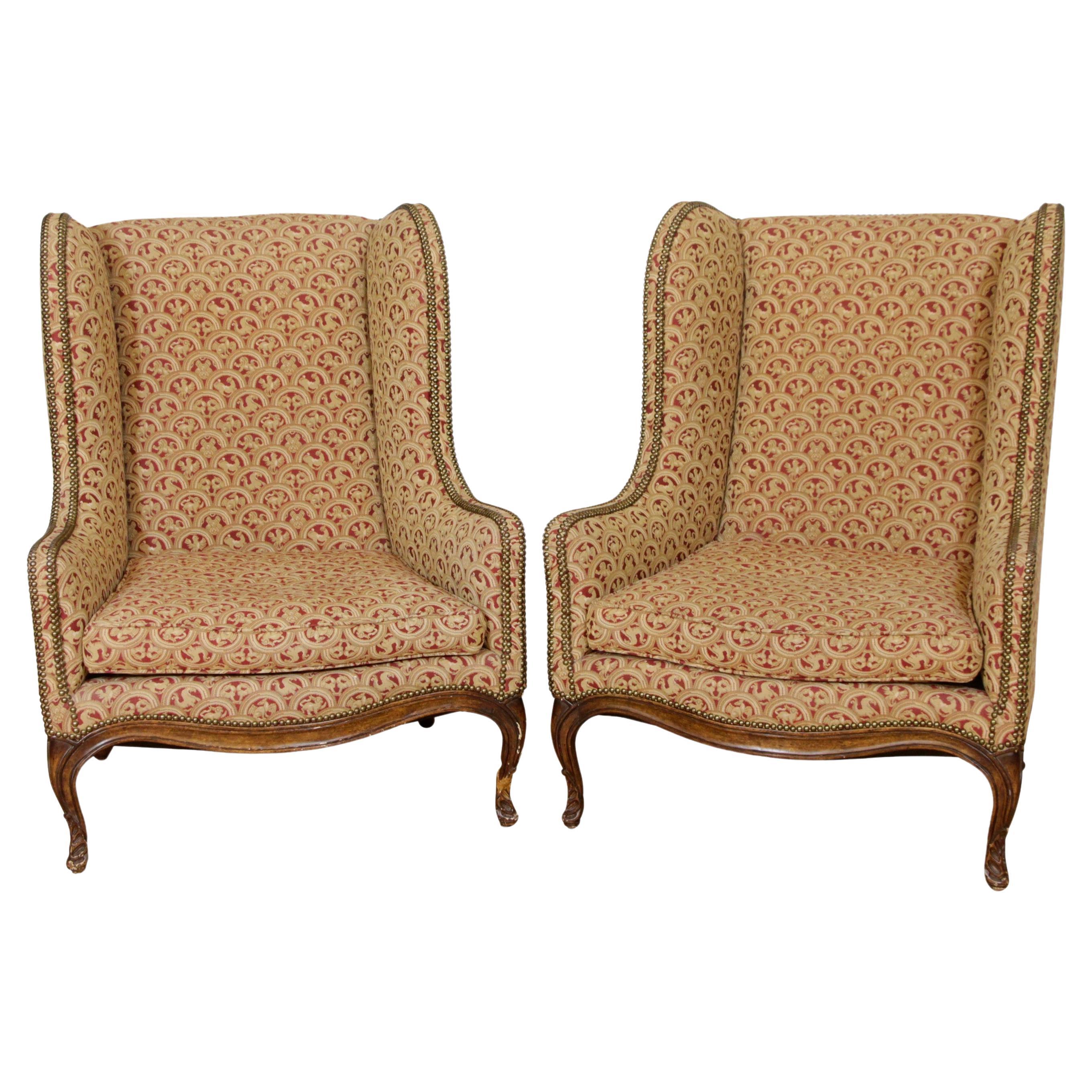 Pair of Upholstered Tan Wing Back Chairs w/ Ornate Figural Details