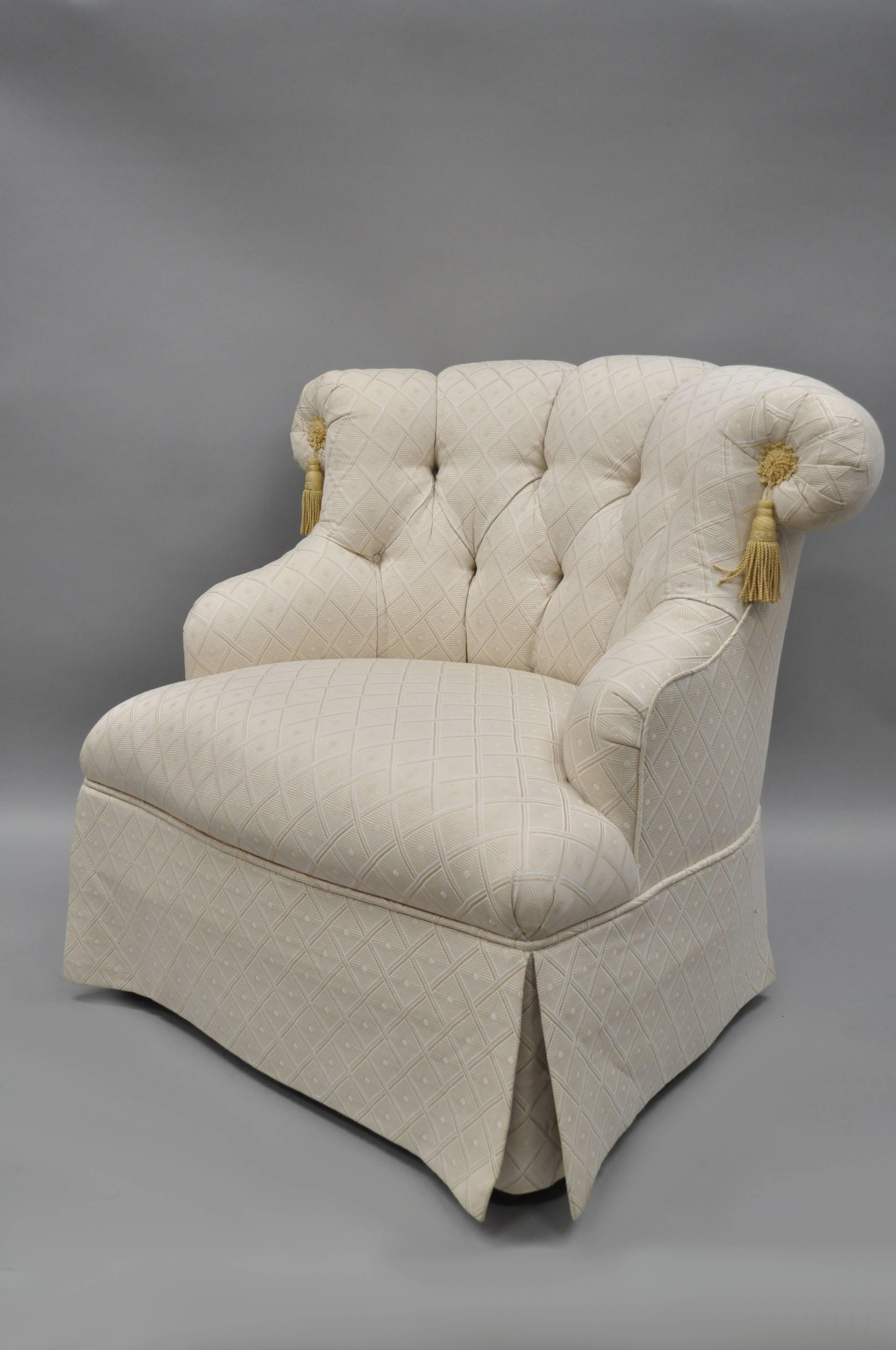 Pair of upholstered and button tufted slipper lounge chairs by Tomlinson Erwin Lambeth in the Napoleon III style. Chairs feature solid wood frames, rolled backs, button tufted upholstery, gold tassels, skirted base, and original label.
