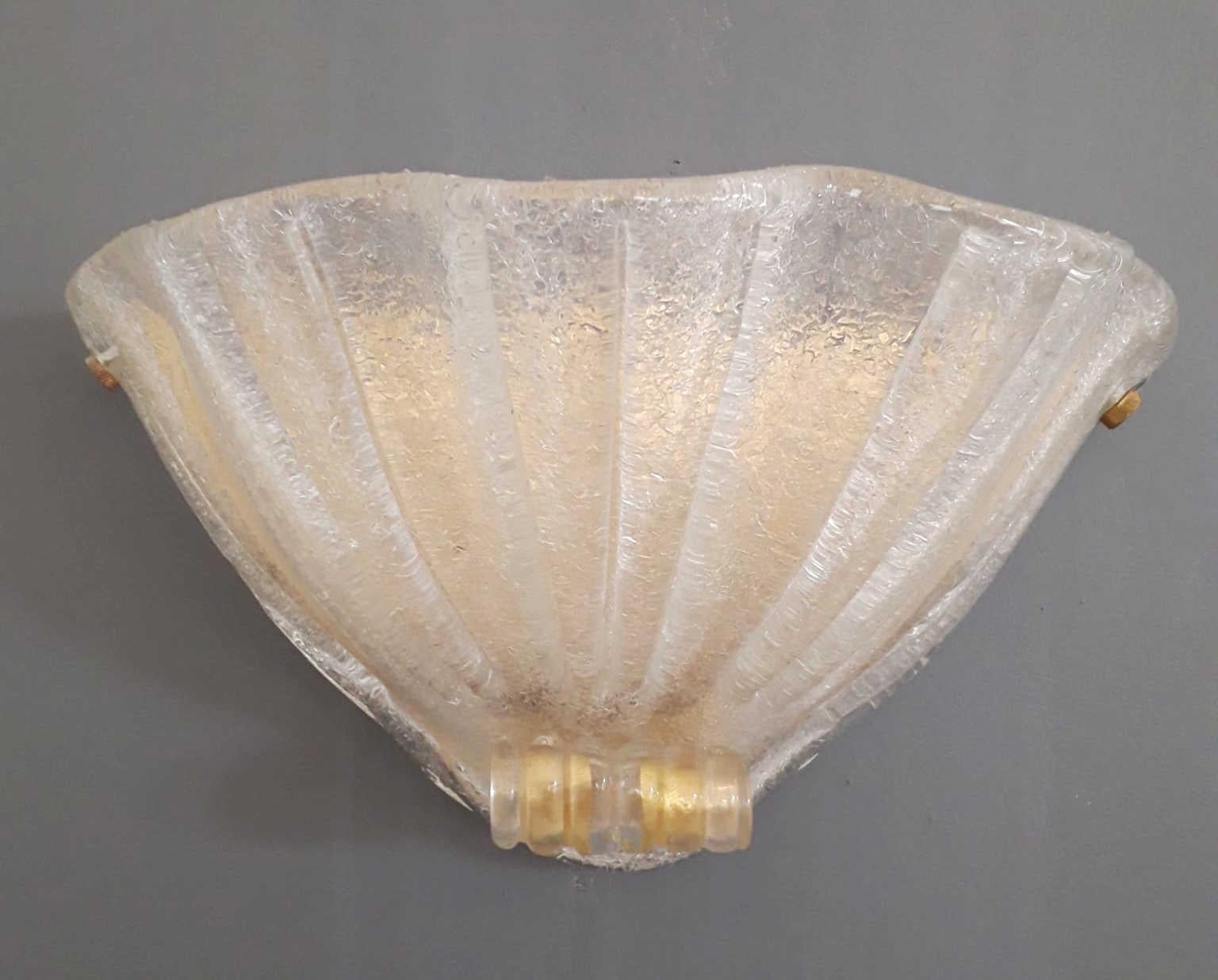 Vintage Italian Murano glass uplight sconces hand blown with graniglia technique to produce granular textured effect and infused with gold flecks, mounted on brass frames / Made in Italy, circa 1960s.
Measures: width 15.5 inches / Height 10 inches