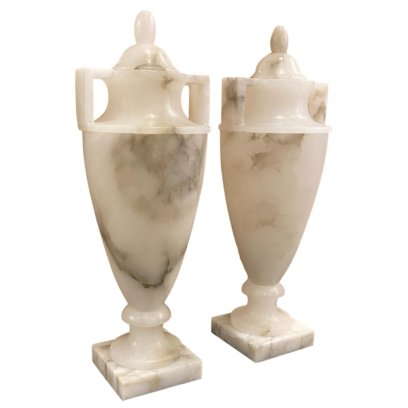 Pair of circa 1950's Italian carved and lidded urn-shaped alabaster table lamps with interior light.

Measurements:
Height: 17.5