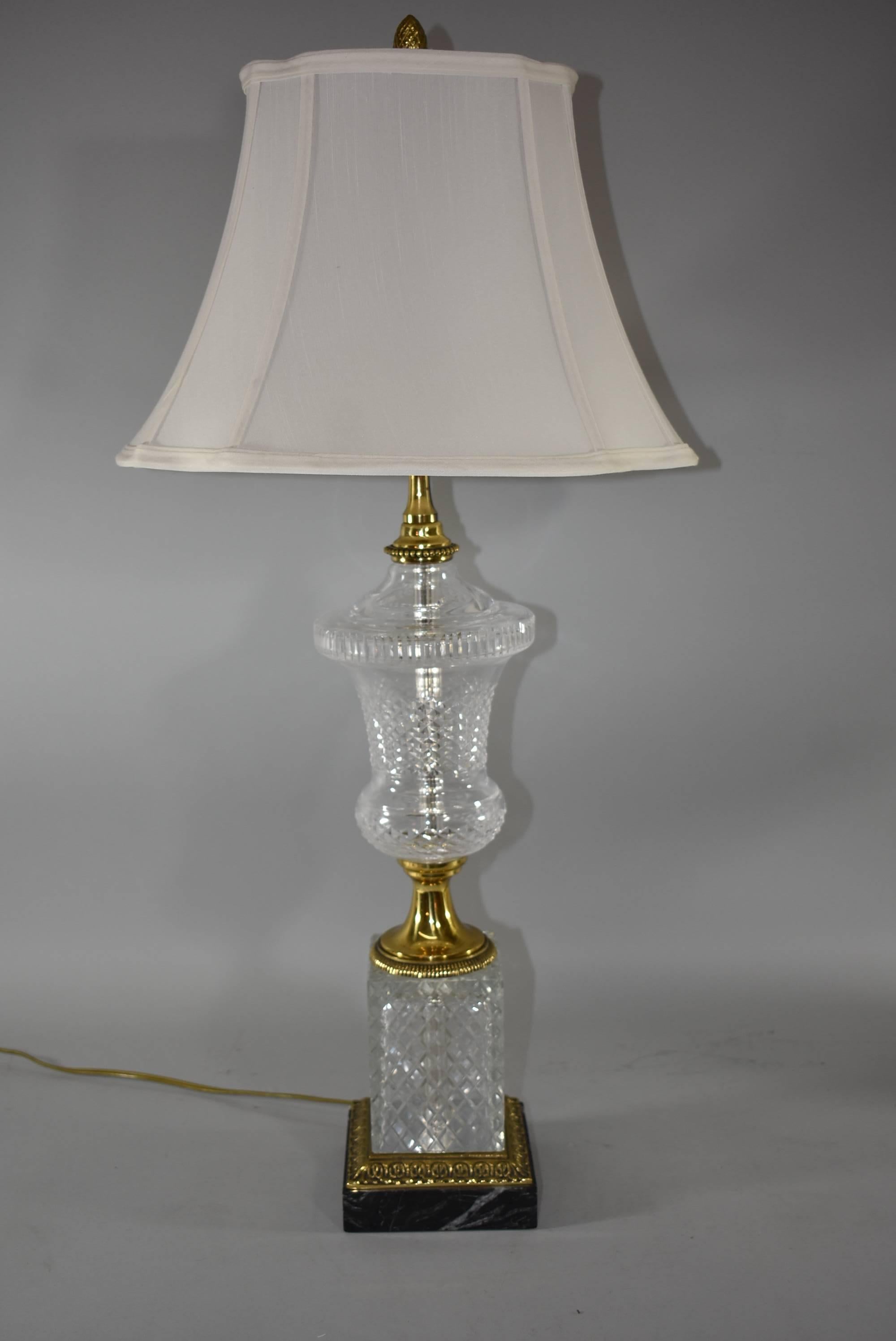 Une étonnante paire de lampes en verre taillé et en marbre de Paul Hanson. Ces magnifiques lampes sont dotées d'une base en marbre noir et blanc, de lourdes montures en laiton moulé et d'un verre en forme d'urne magnifiquement taillé. La lampe