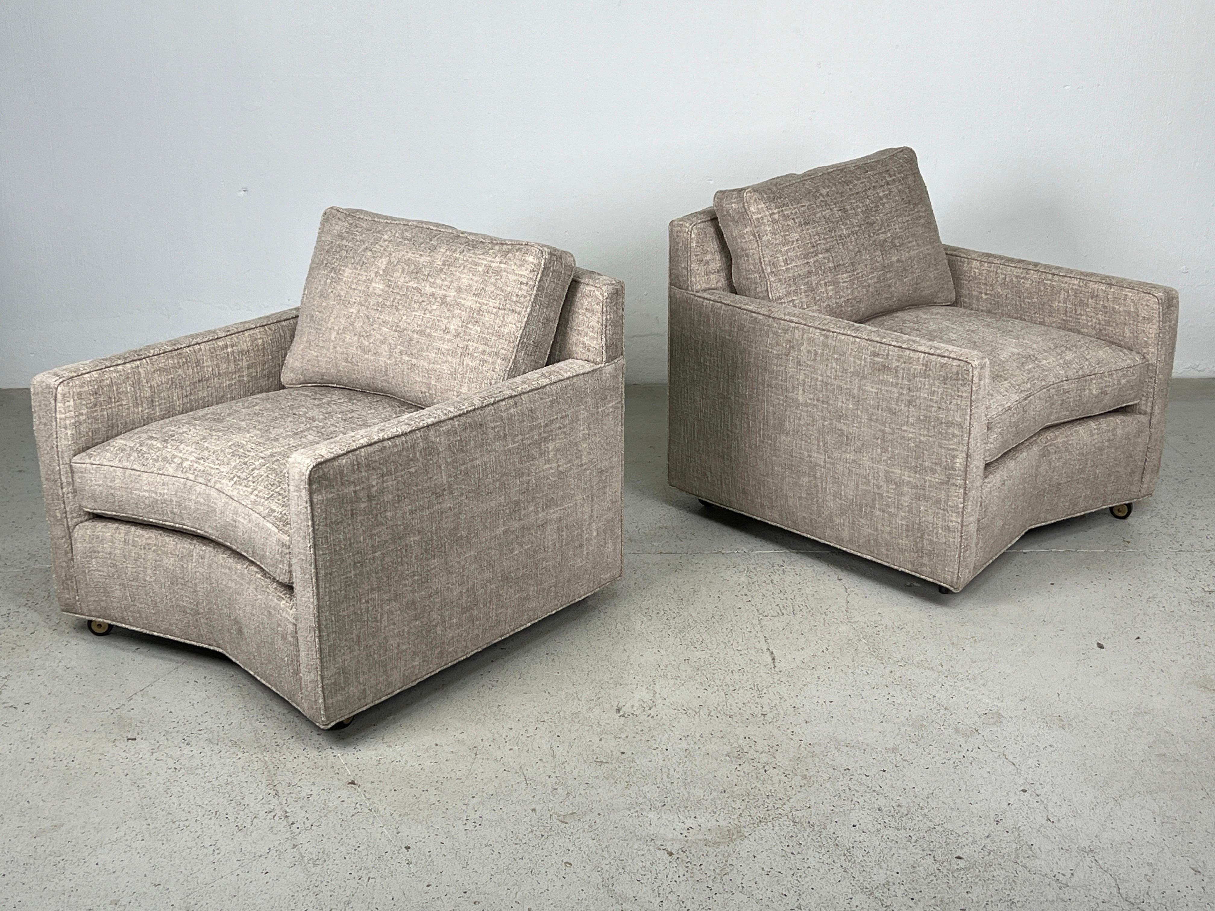 A large scale pair of angled lounge chairs with down cushions by Baker. Fully restored and reupholstered. 