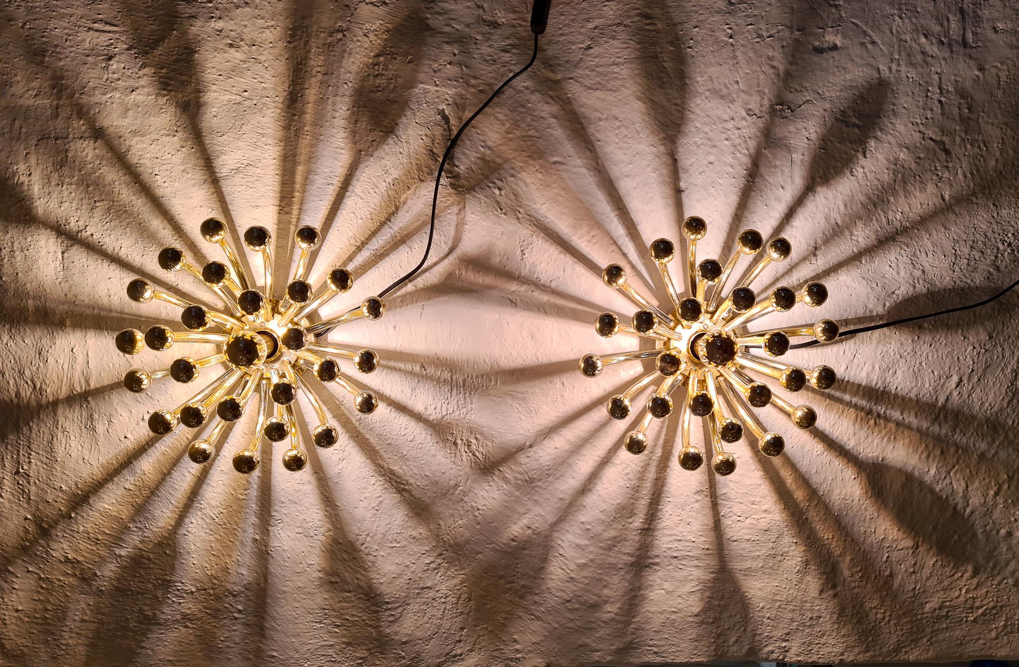 A Classic wonderful pair of wall lamps in stylish modern design. The Pistillino lamp can be used as a table lamp and wall sconce. 

The lamp has a gold mirror finish and a single gold mirror topped light bulb in the center. This mirror topped bulb