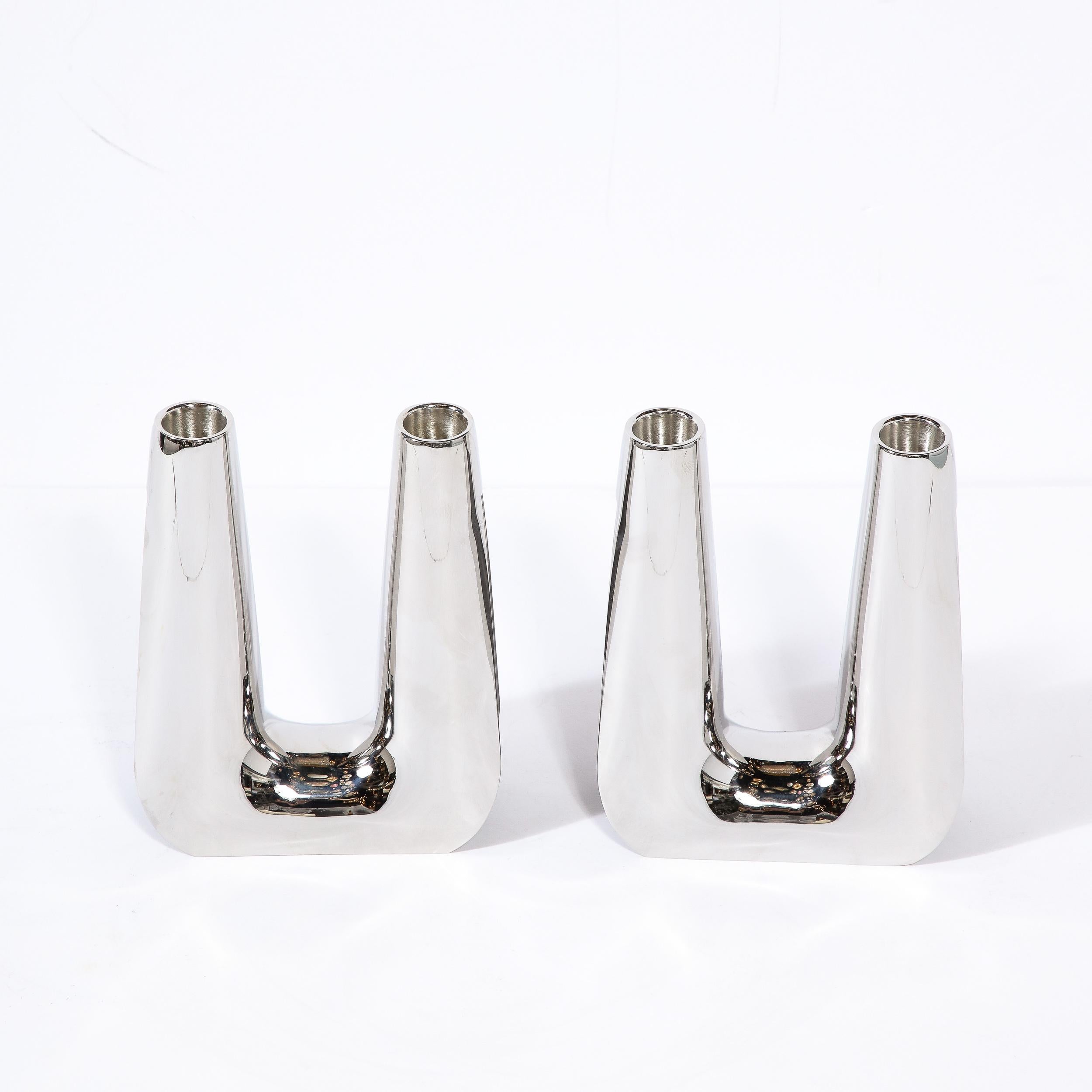 This beautifully sculpted Pair of Valley Form Two Light Candelabras in Stainless Steel are designed by esteemed silversmith and manufacturer George Jensen in Denmark during the 20th Century. Highly modern and minimal in their design while