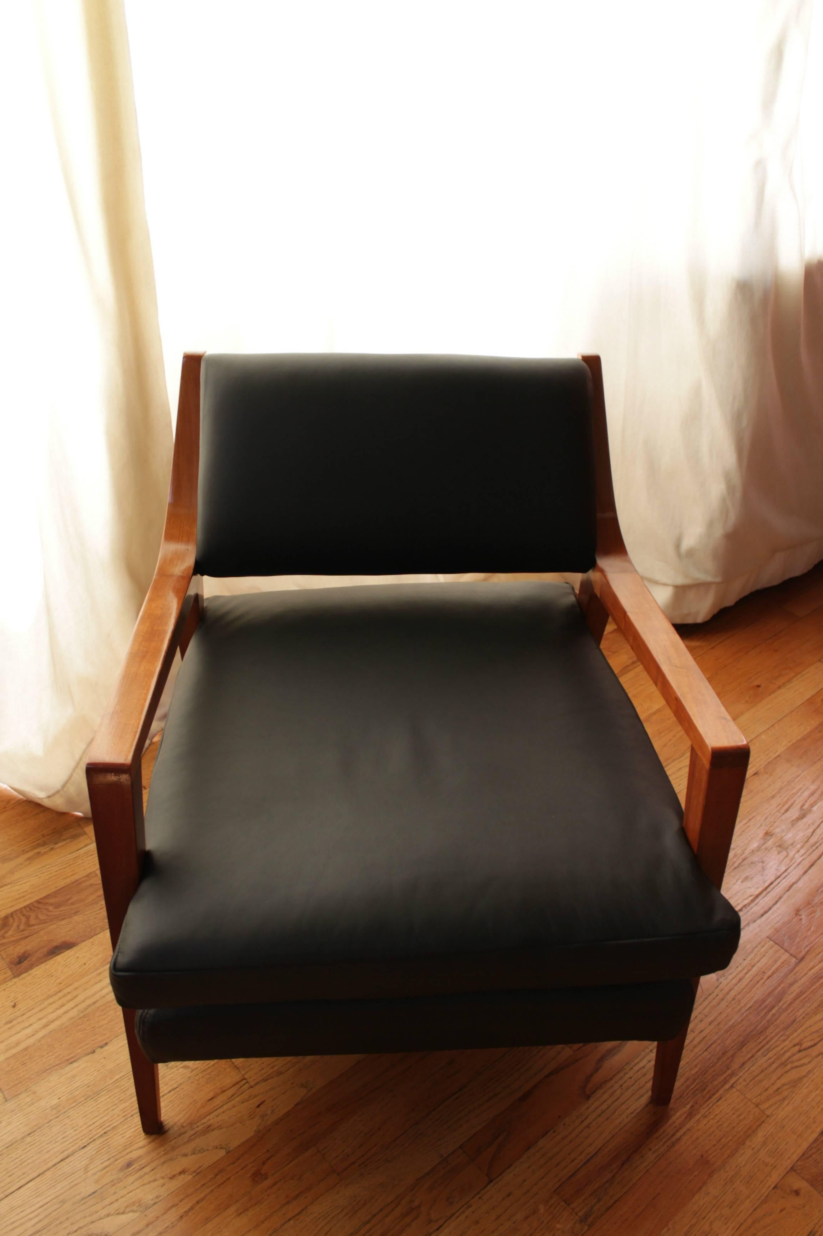 Pair of Van Beuren chairs made of mahogany wood with black leather seats.
