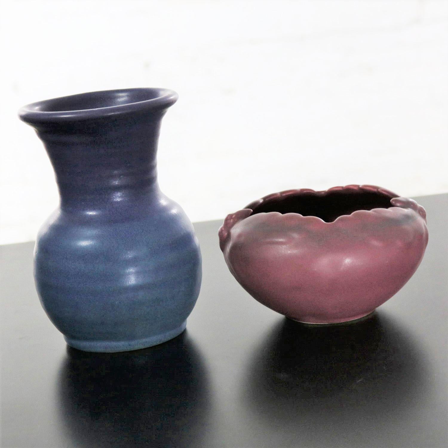 Handsome pair of Van Briggle pottery pieces consisting of an acorn bowl in Persian Rose glaze and a hand thrown vase by Roland Wick in Lilac Blue. Both are in wonderful vintage condition with no chips, cracks, or chiggers. Please see photos. Bowl is