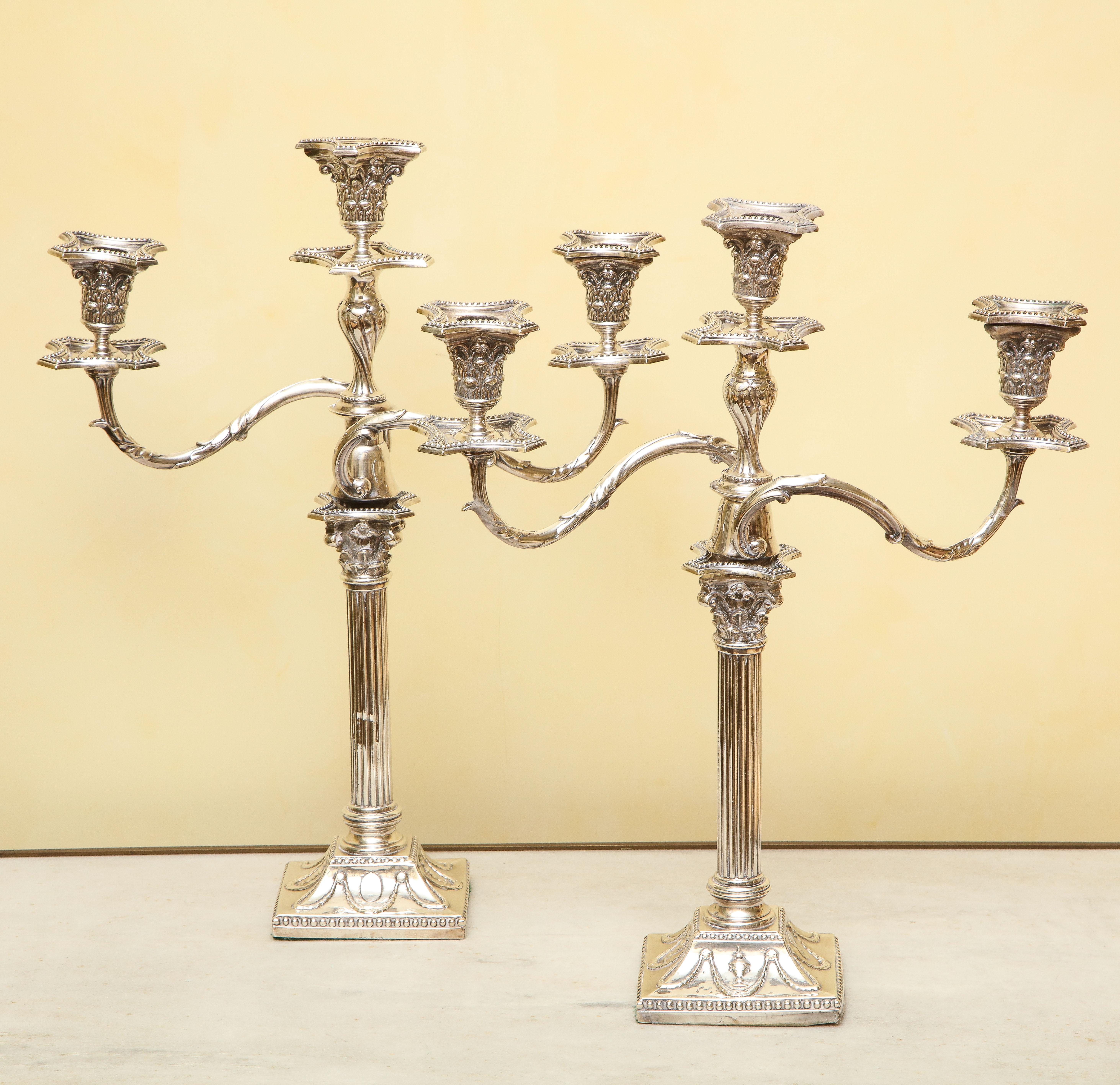 A pair of silver-plated George III-style convertible candelabra candlesticks. The three-light Gilded Age Georgian style candelabra branches detach into a single pair of candlesticks to allow for conversion. 

Provenance: “Rock Cliff”, formerly