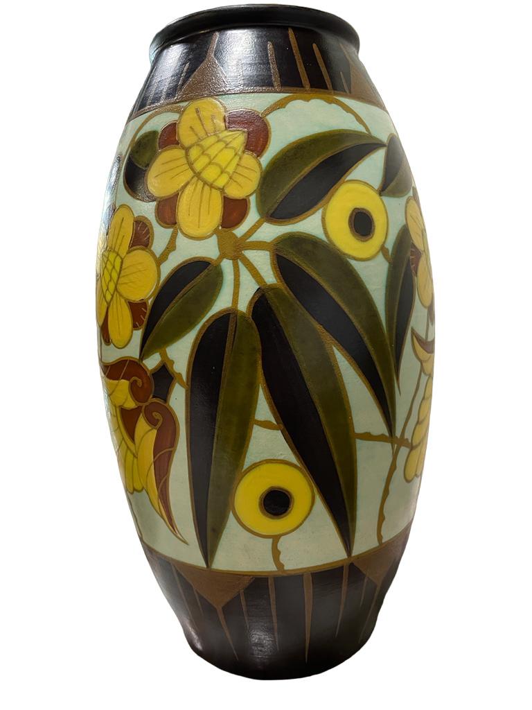 Pair of Vases by Boch Freres Keramis after Charles Catteau.
From the shoulder to the body runs a frieze of stylised flowers and leaves. Neck and foot dark chestnut, decorated with stripes and triangles in ochre slip.

Decoration with printed