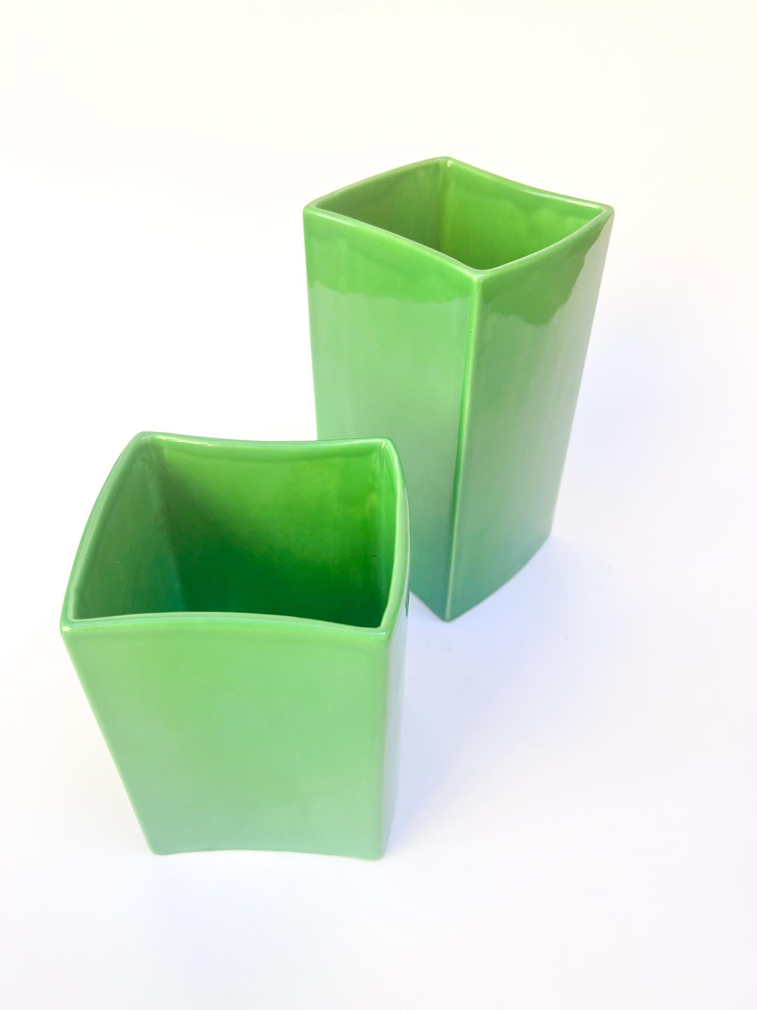 Pair of green vases by Franco Bettonica for Ceramica Gabbianelli, made in the 1970s.

Big one: Ø cm 11.5 Ø cm 10 H cm 20
Small one: Ø cm 11.5 Ø cm 10 H cm 15

Both vases have a tiny chip in one top angle. Additional pictures can be send upon