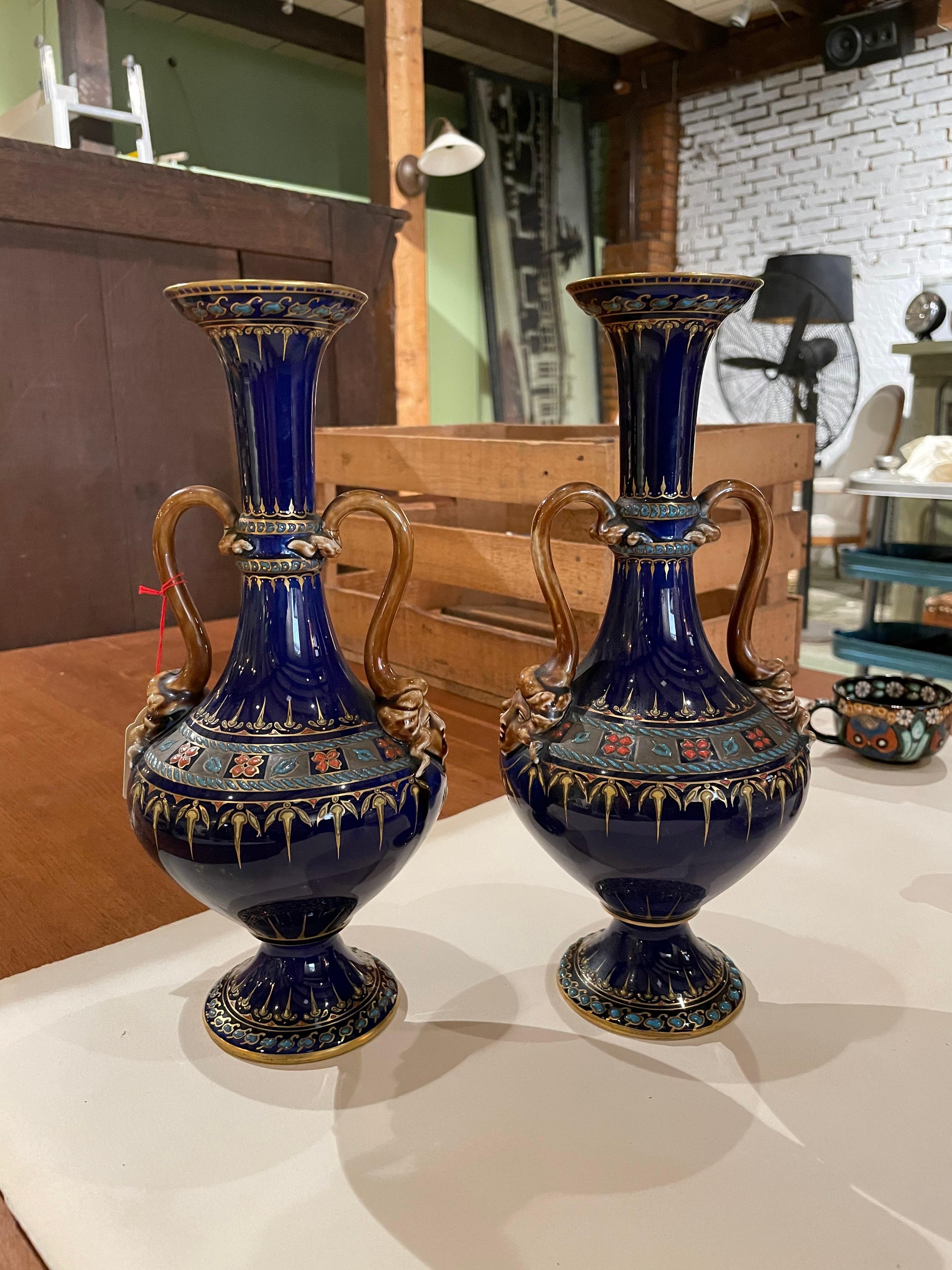 Rare hand painted vases in cobalt blue with lots of decorations and particular heads on both sides. Marked 1140/8 and the authentic label left.
