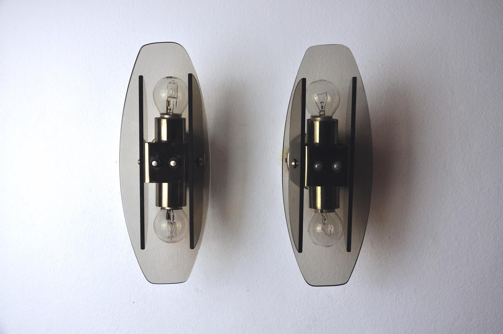Very nice pair of veca wall lights produced in italy in the 70s. Wall lights composed of cut glass plates and a chrome structure. Unique object that will illuminate wonderfully and bring a real design touch to your interior. Electricity checked,