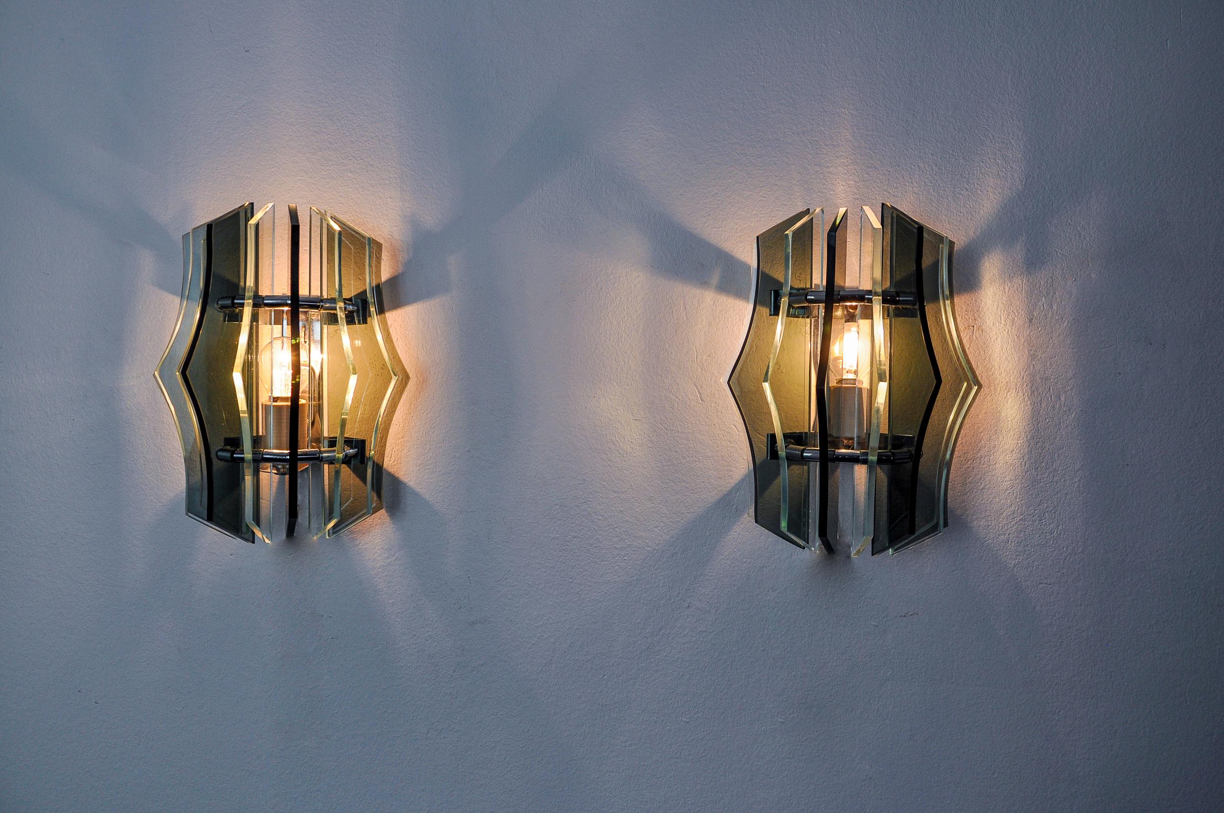 Very beautiful and rare pair of green veca wall lights designed and produced in Italy in the 70s. Wall lights made up of green cut glass plates and a chrome metal structure. Unique object that will illuminate wonderfully and bring a real design