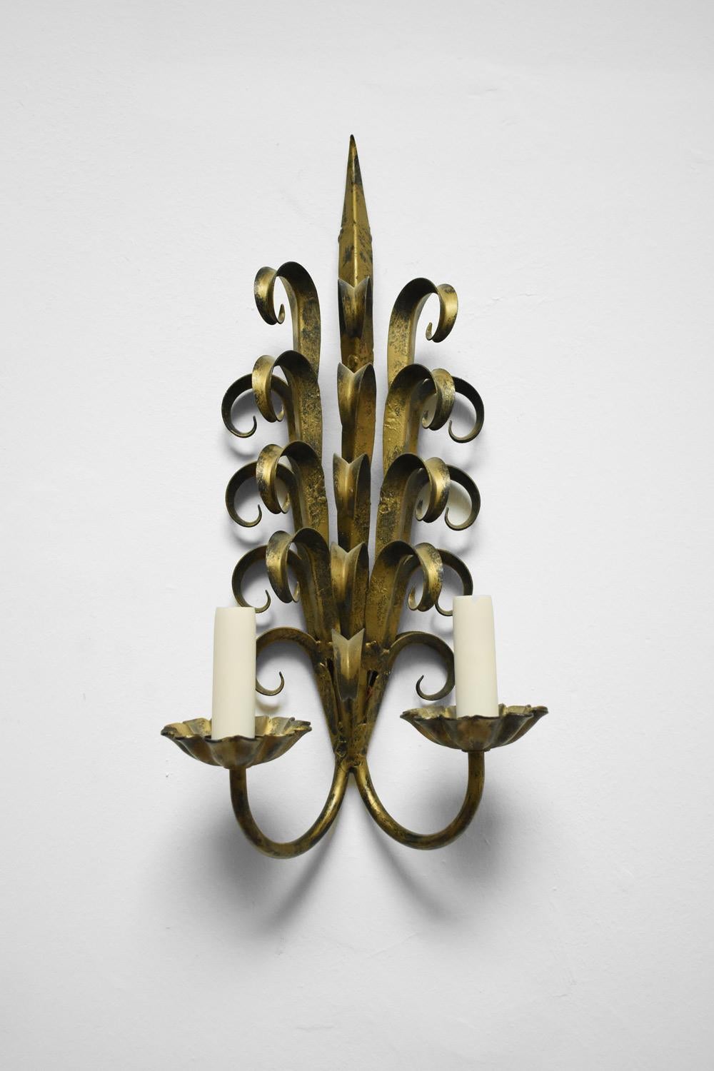 Pair of gilded iron wall sconces with a floral pattern. France, 1970s.