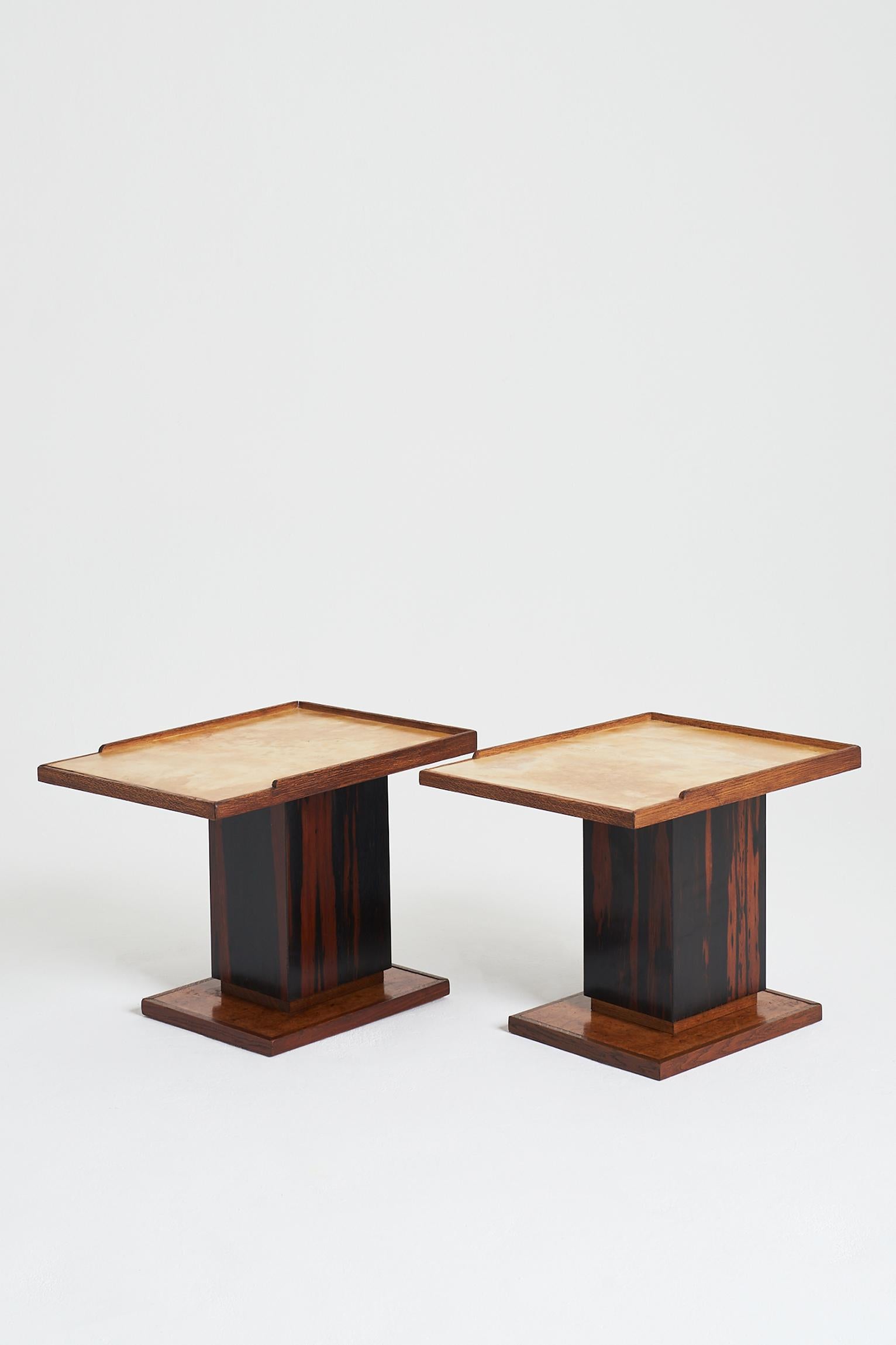 A pair of velum topped, torn oak, burr walnut and Makassar ebony side tables, in the manner of Paul Paul-Dupré Lafon.
France, Circa 1940-50.
