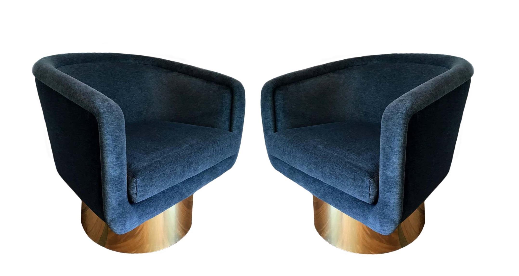 Pair of swivel club/lounge chairs designed by Leon Rosen for The Pace Collection, circa 1970. Upholstered barrel back frames with loose cushion. Newly reupholstered in a velvet fabric with polished brass cylindrical pedestal bases. These chairs are