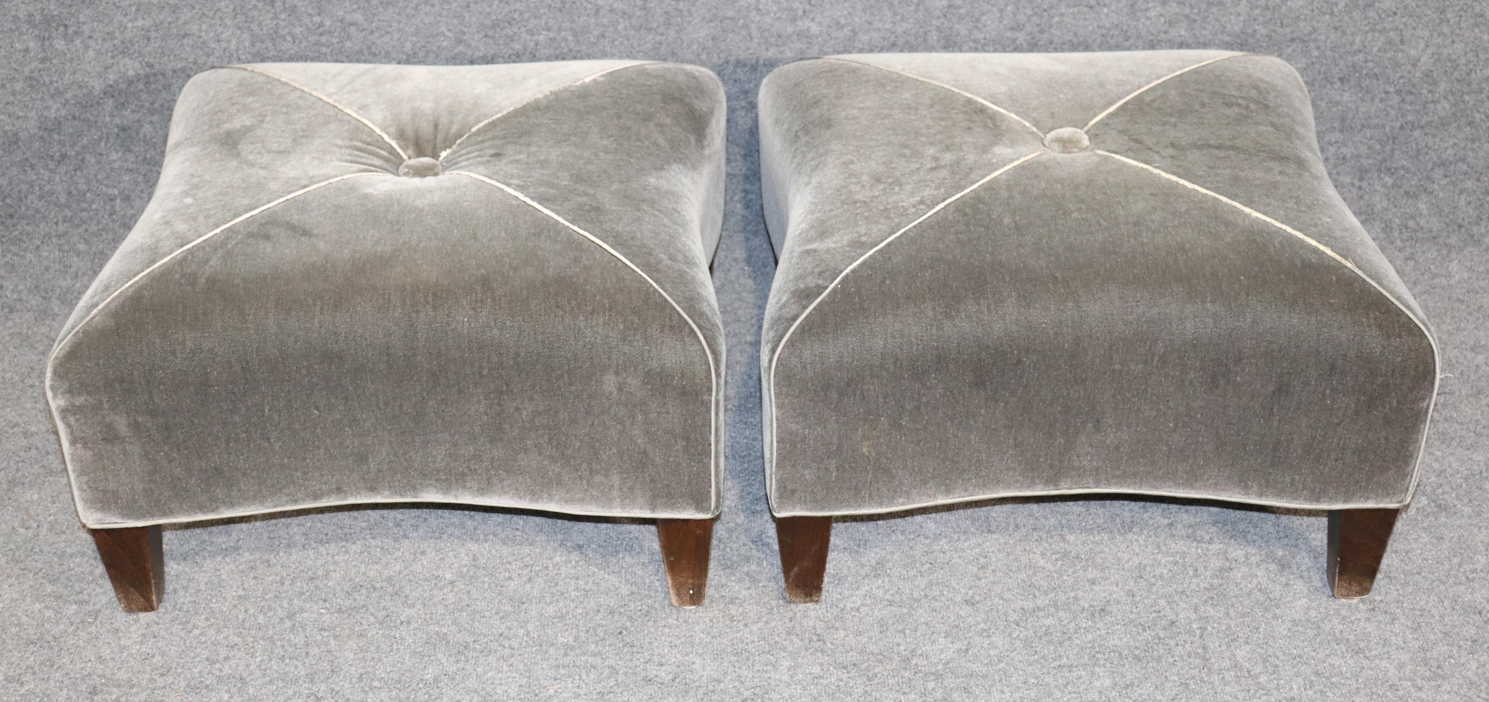 Pair of soft grey ottomans with wood feet. Simple and elegant shape with single button tufting.
Please confirm location.

