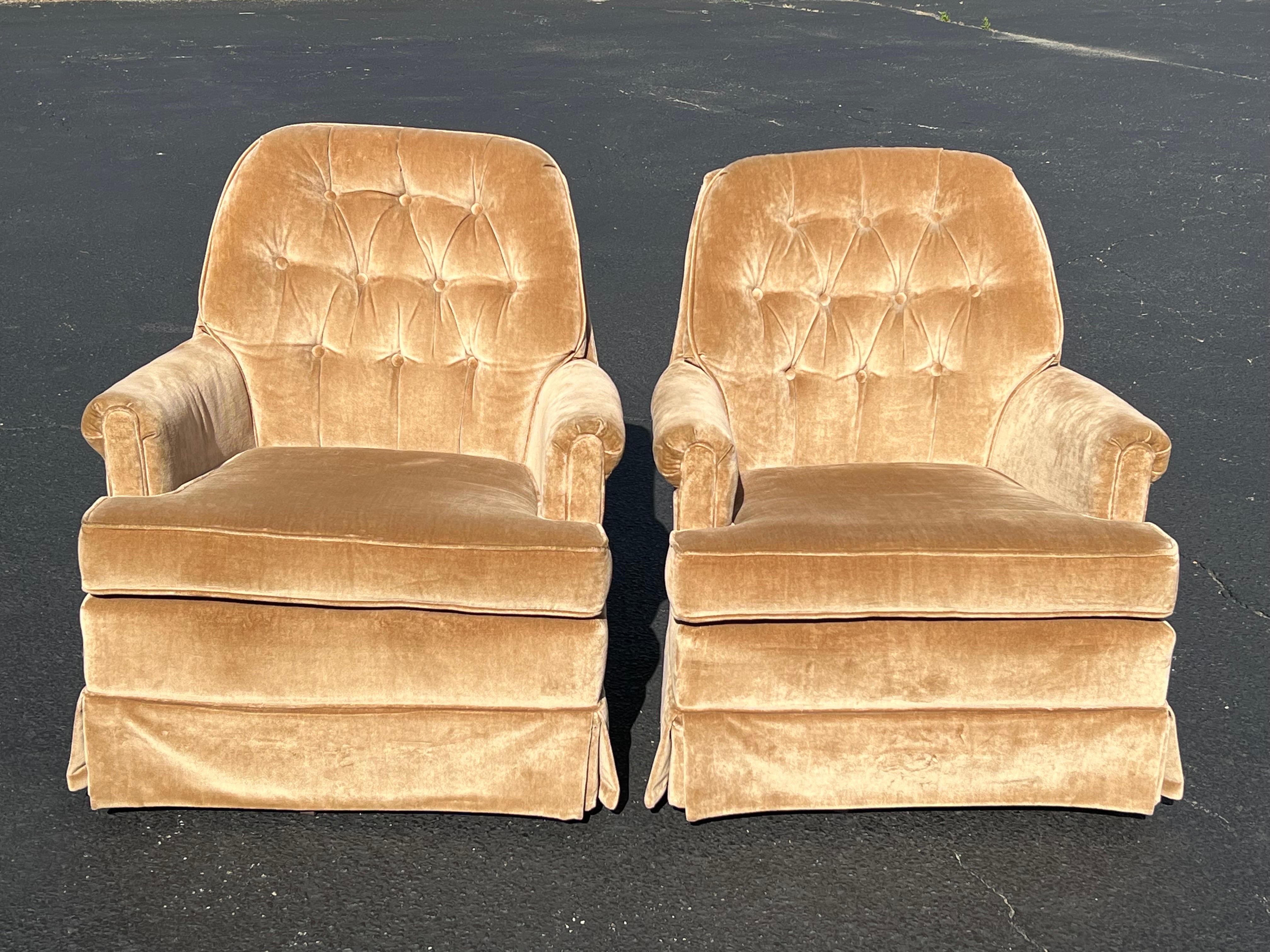 Pair of Hollywood Regency style Velvet swivel chairs in champagne. This velvet is a pale camel color. Very neutral which will go with many colors. These chairs do not need reupholastery. They in very good condition . These chairs swivel and rock.