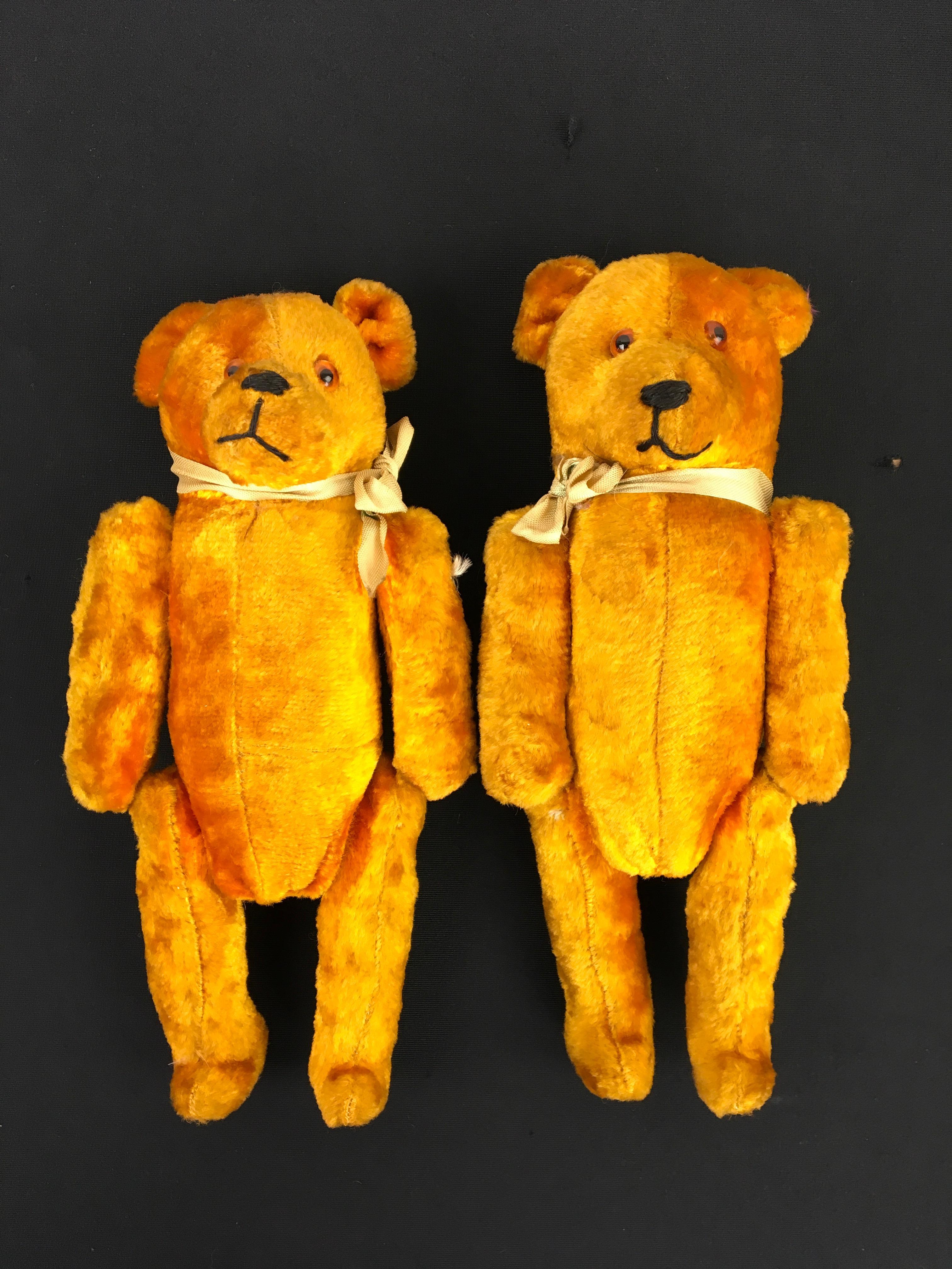 Pair of antique velvet toy bears. 
Gold - brown - yellow velvet bears with glass eyes and straw stuffed. 
With sewn mouth and nose and movable arms and legs. 
Looks like a couple ( male and female ) as there heads are different in size. 

Beautiful