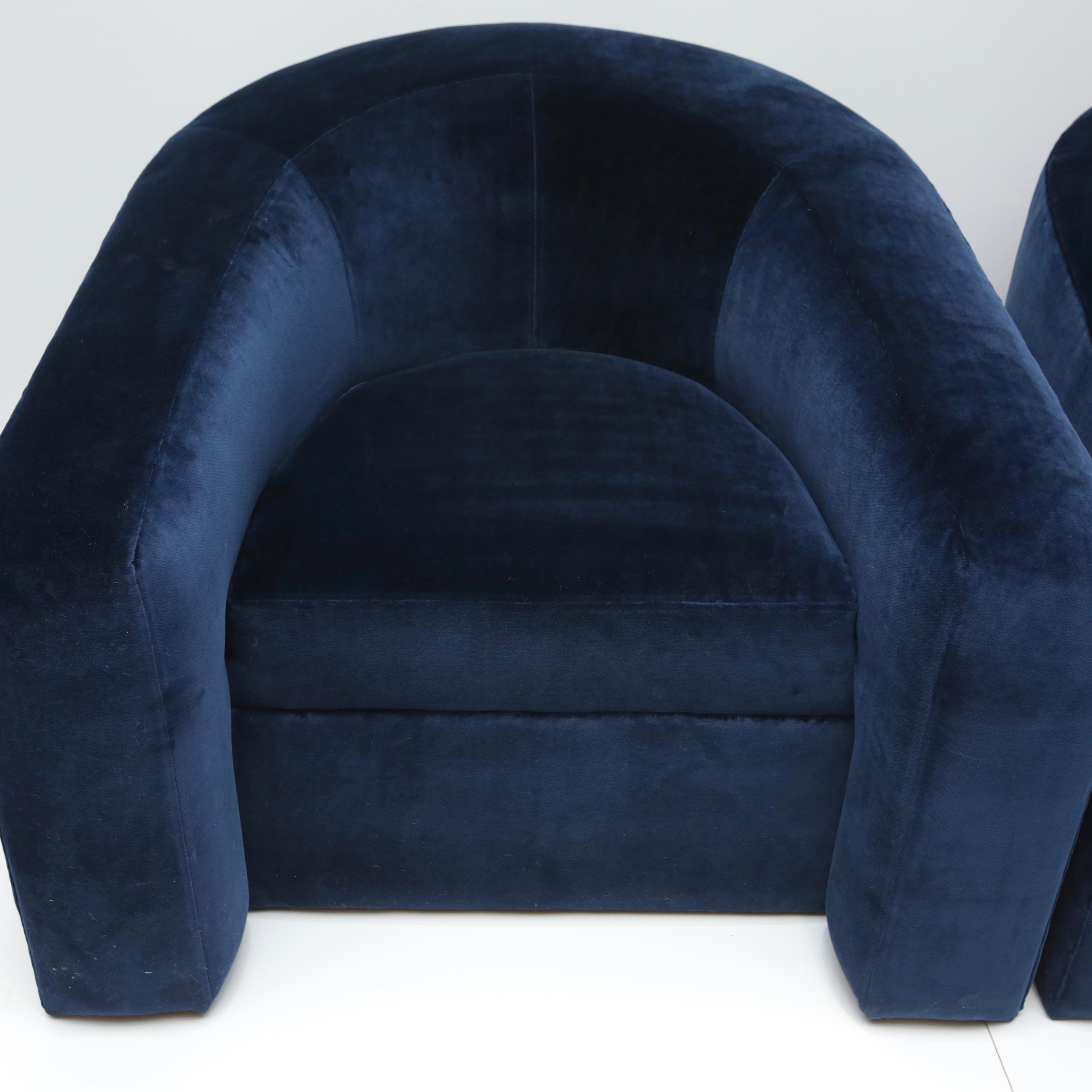Super comfy tub chairs covered in deep navy blue Kravet cotton velvet. Chairs are modeled after the Donghia volume tub chair.