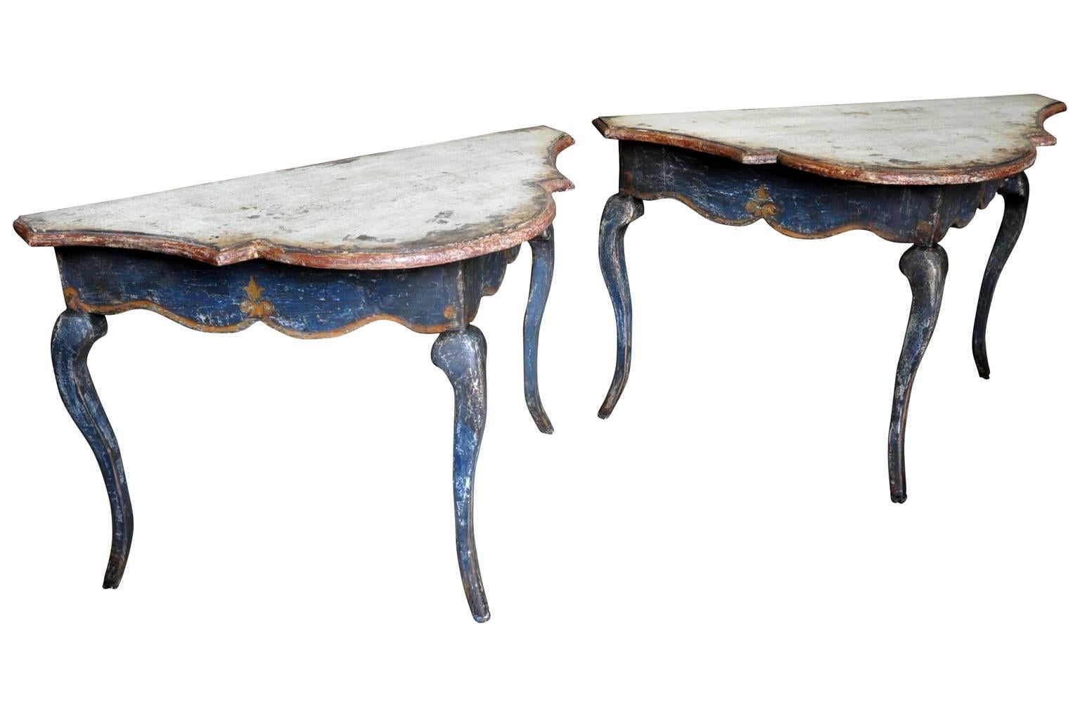 A wonderful pair of Venetian 17th century style painted console tables - demilunes, constructed from antique wood and artistically hand-painted. Wonderful finish and texture - very sumptuous color.