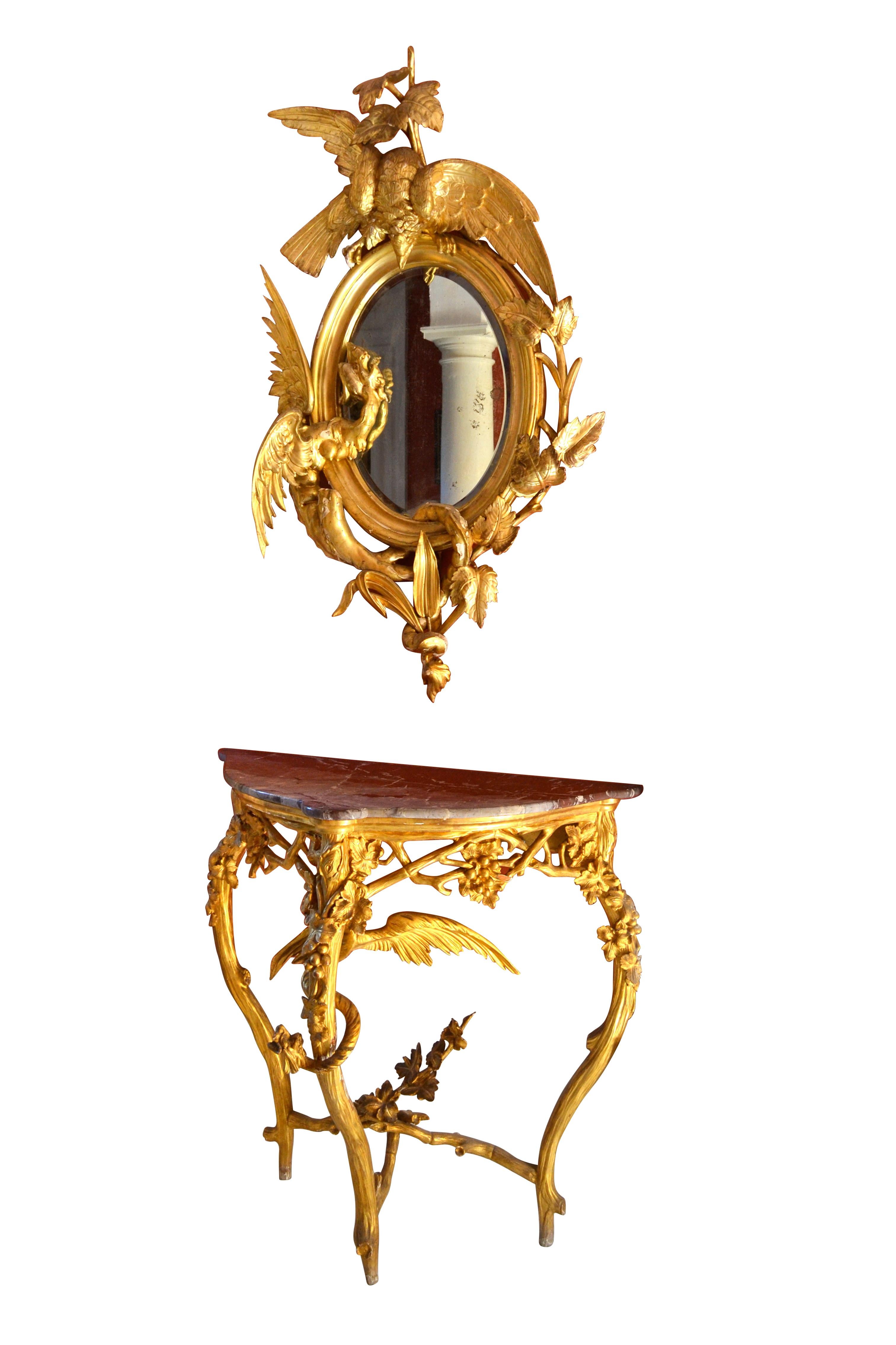 A rare, unique and dramatic pair of Rococo style marble topped giltwood triangular shaped consoles and complimentary slightly elliptical giltwood mirrors. The four pieces are believed to be northern Italian most likely from the Venetian region. The
