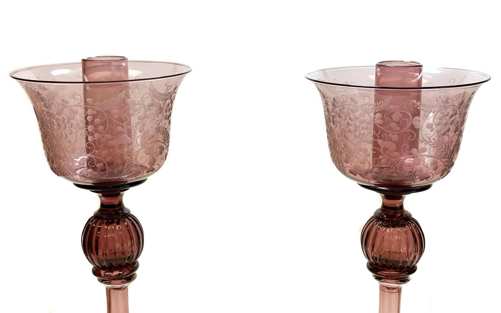 Pair of Venetian Amethyst Glass Engraved floral tall candlesticks, Mid Century

Engraved flowers, leaves, and vines to the exterior.

Additional Information:
Type: Candlesticks 
Brand: Ventian
Material: Glass
Dimension: 6.75 inches diameter