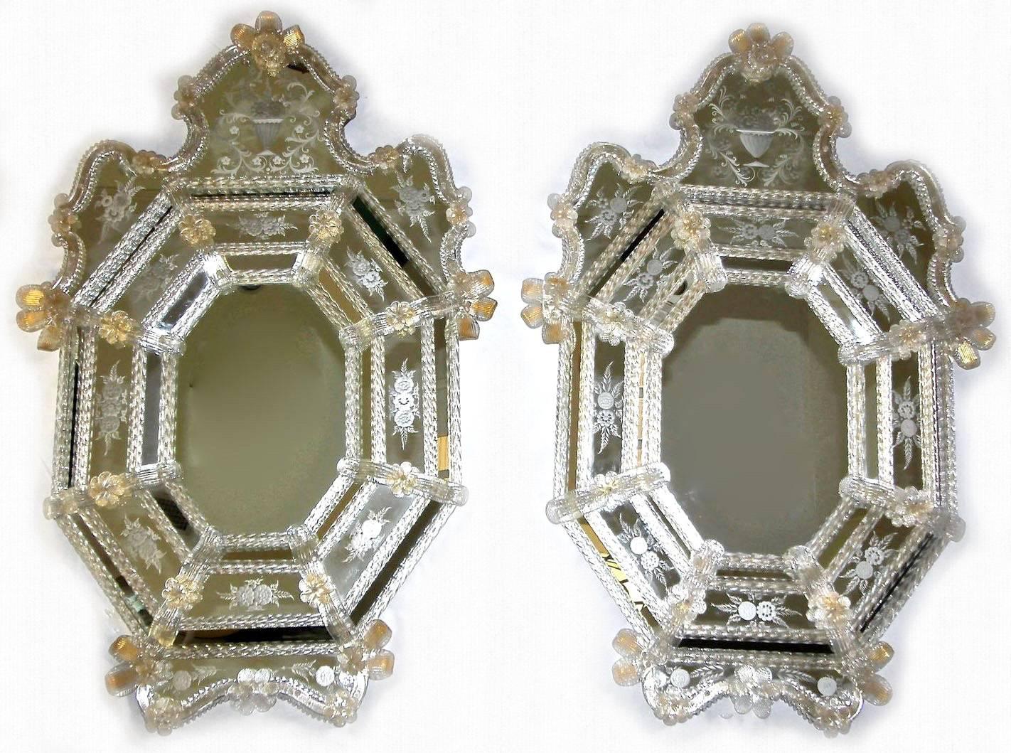 Outstanding pair of Venetian (Murano) Italian wall mirrors with clear and gold inclusion flowers and leaves. The mirrors are surrounded with finely twisted glass rods and intricately etched glass detailing.