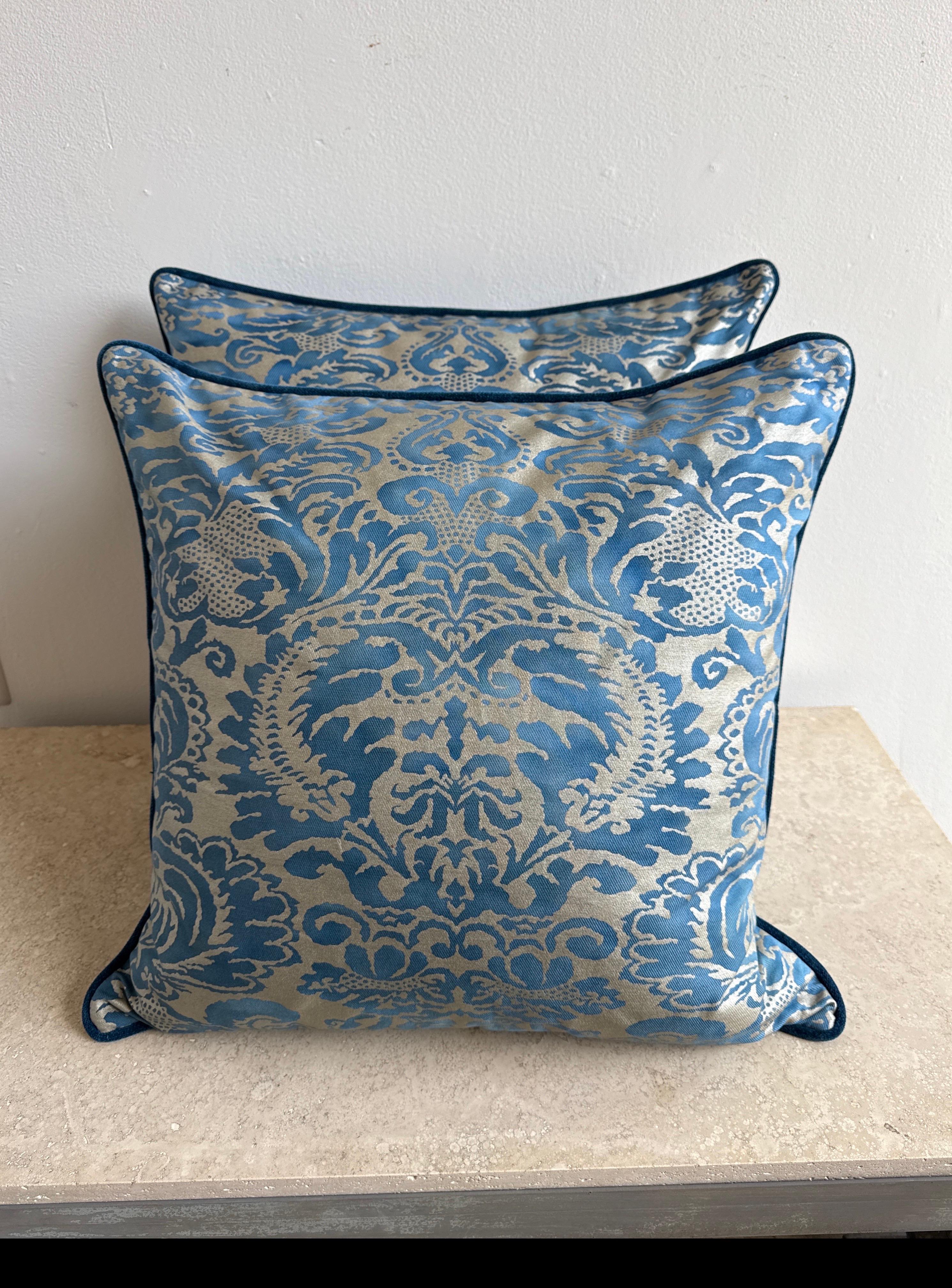 Questi eleganti cuscini sono realizzati con il lussuoso tessuto italiano Fortuny e presentano un ricco motivo damascato in varie tonalità di blu su un morbido fondo beige argentato. Il motivo senza tempo è audace e intricato e offre una sofisticata