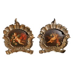 Coppia di ritratti di cherubini fogliati in legno dorato e gesso veneziano C 1780