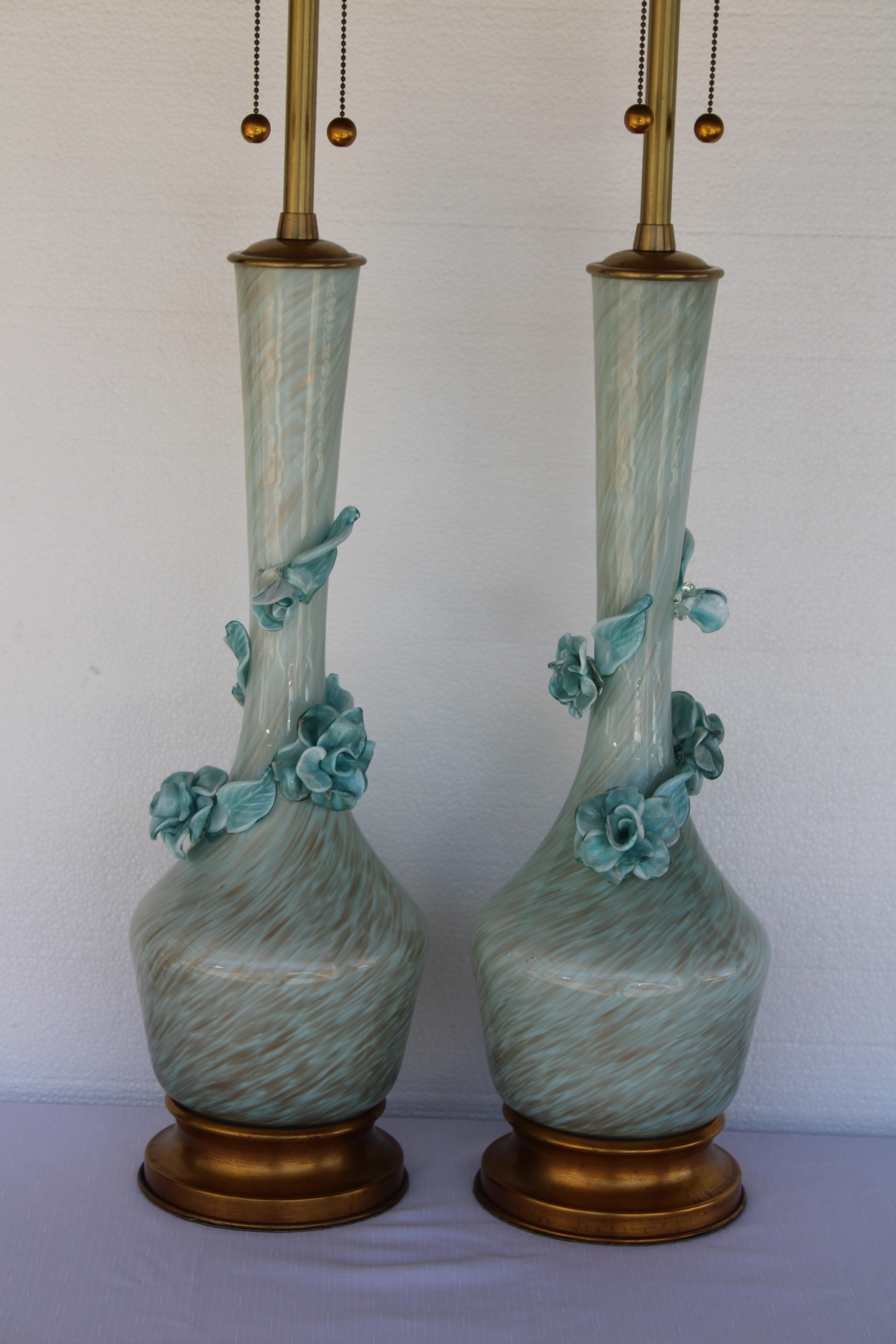 Pair of venetian glass lamps by The Marbro Lamp Company.  Each lamp measures 8” diameter,  44.5” high from base to the top of finial.  Glass portions are 21.5” high.  Lamps have been professionally rewired.
     