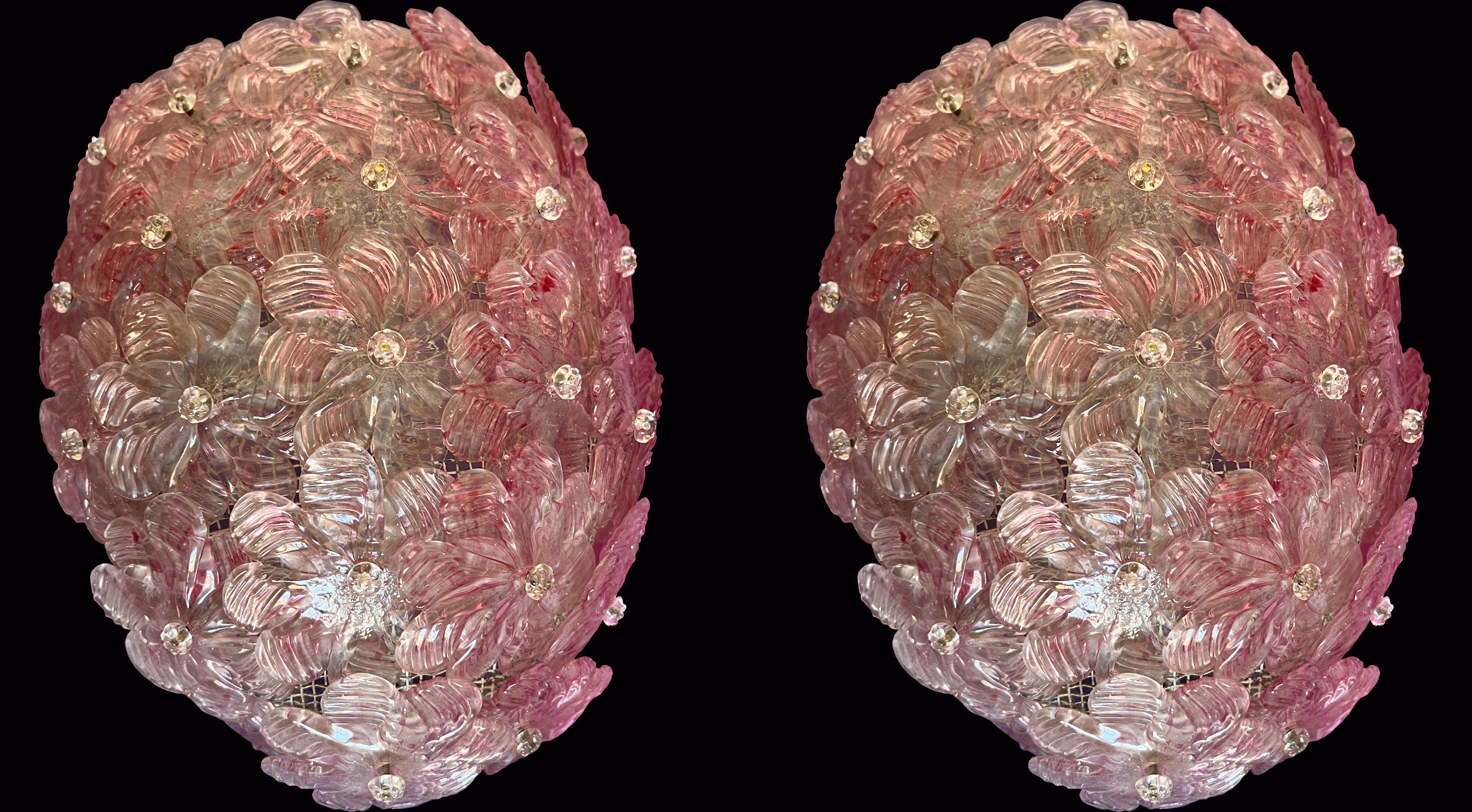 Pair of stunning bright pink colored wall lights. They are formed by dozens of small roses made of pure Murano glass.